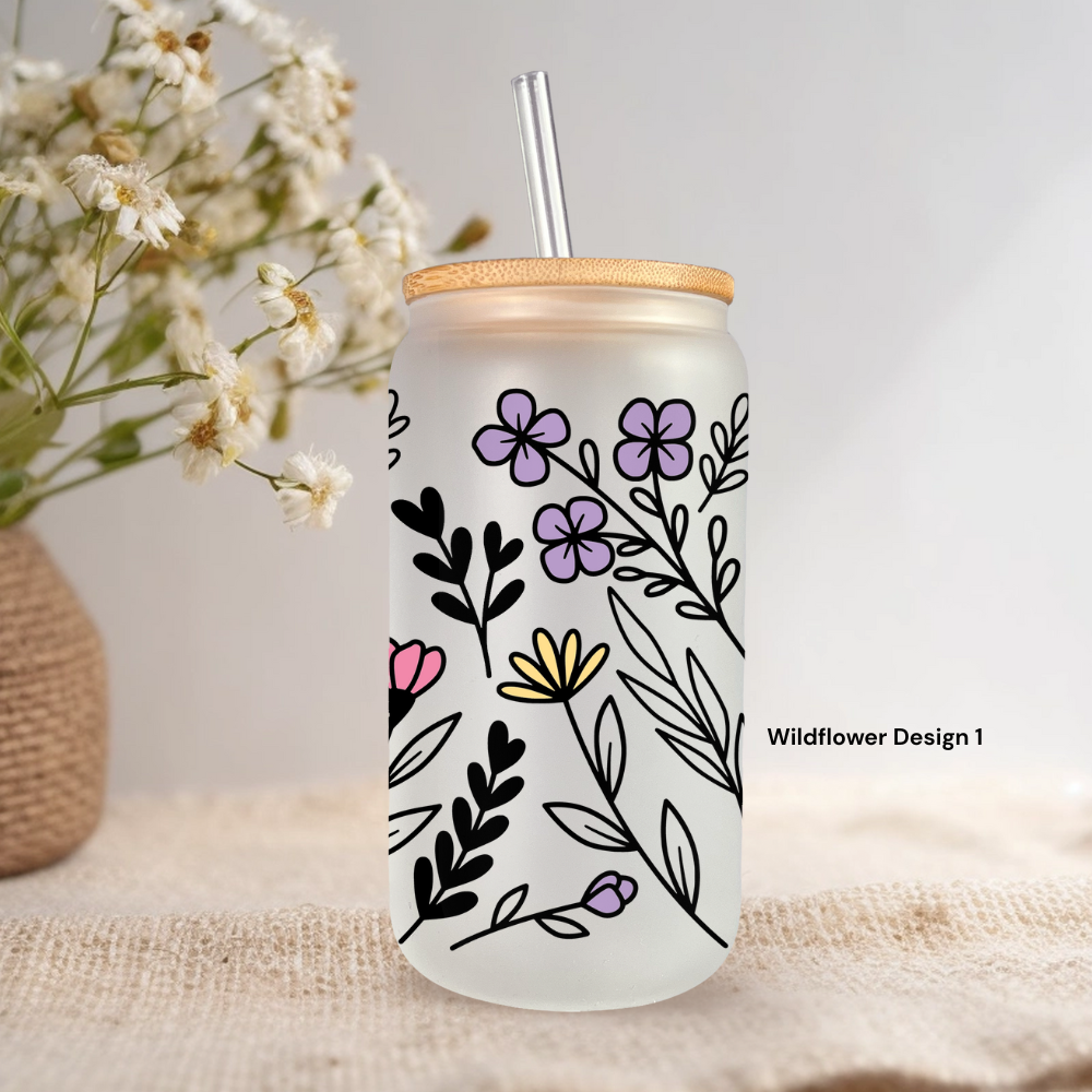 Frosted wildflower tumbler with bamboo lid staged against textured neutral background