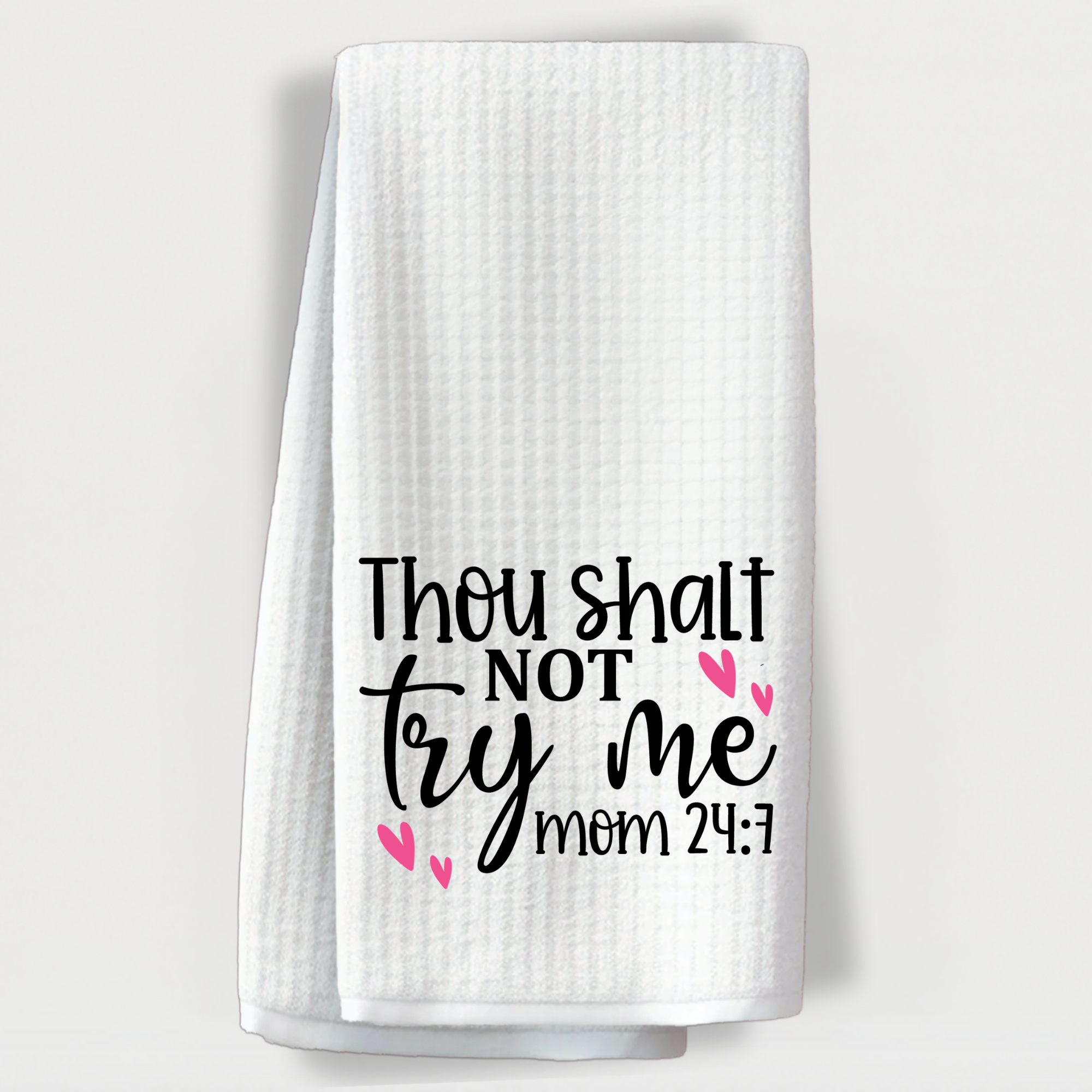 White waffle weave towel with funny mom quote 'Thou shalt not try me – Mom 24:7' and pink heart accents.