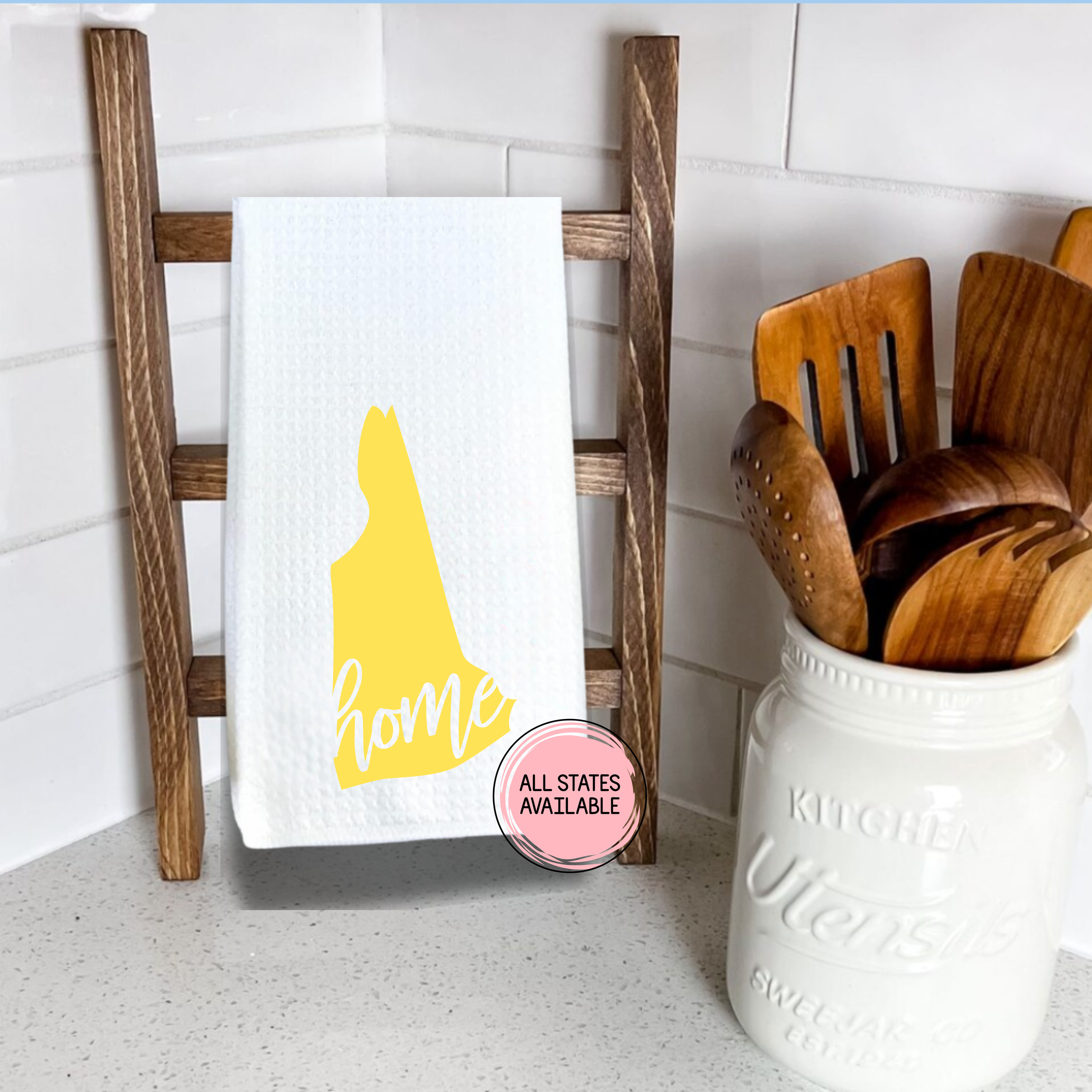 Delaware home state waffle weave kitchen towel in yellow displayed on a wooden ladder rack in a cozy kitchen corner.