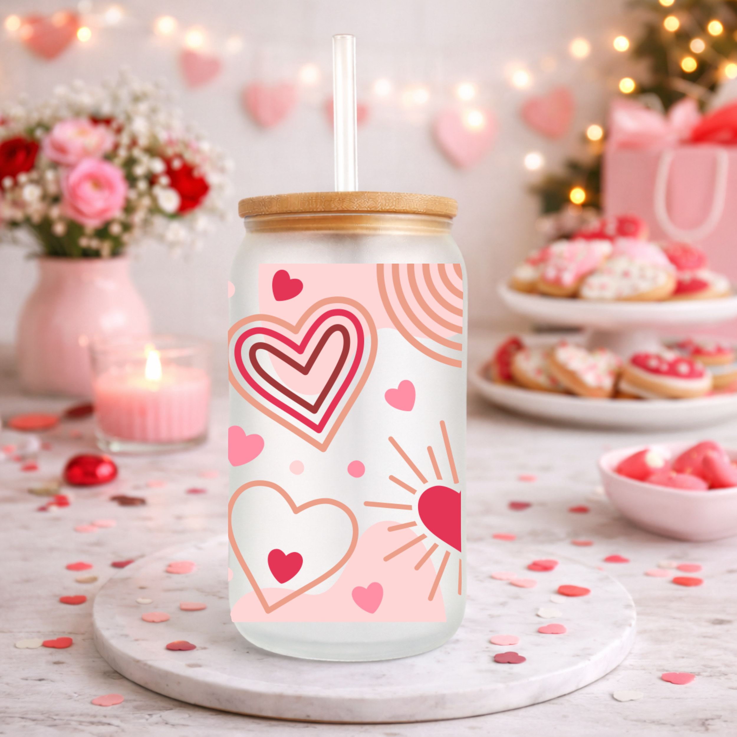 Valentine heart design frosted glass can cup styled on a dessert table with cookies, candles, and pink Valentine decorations.