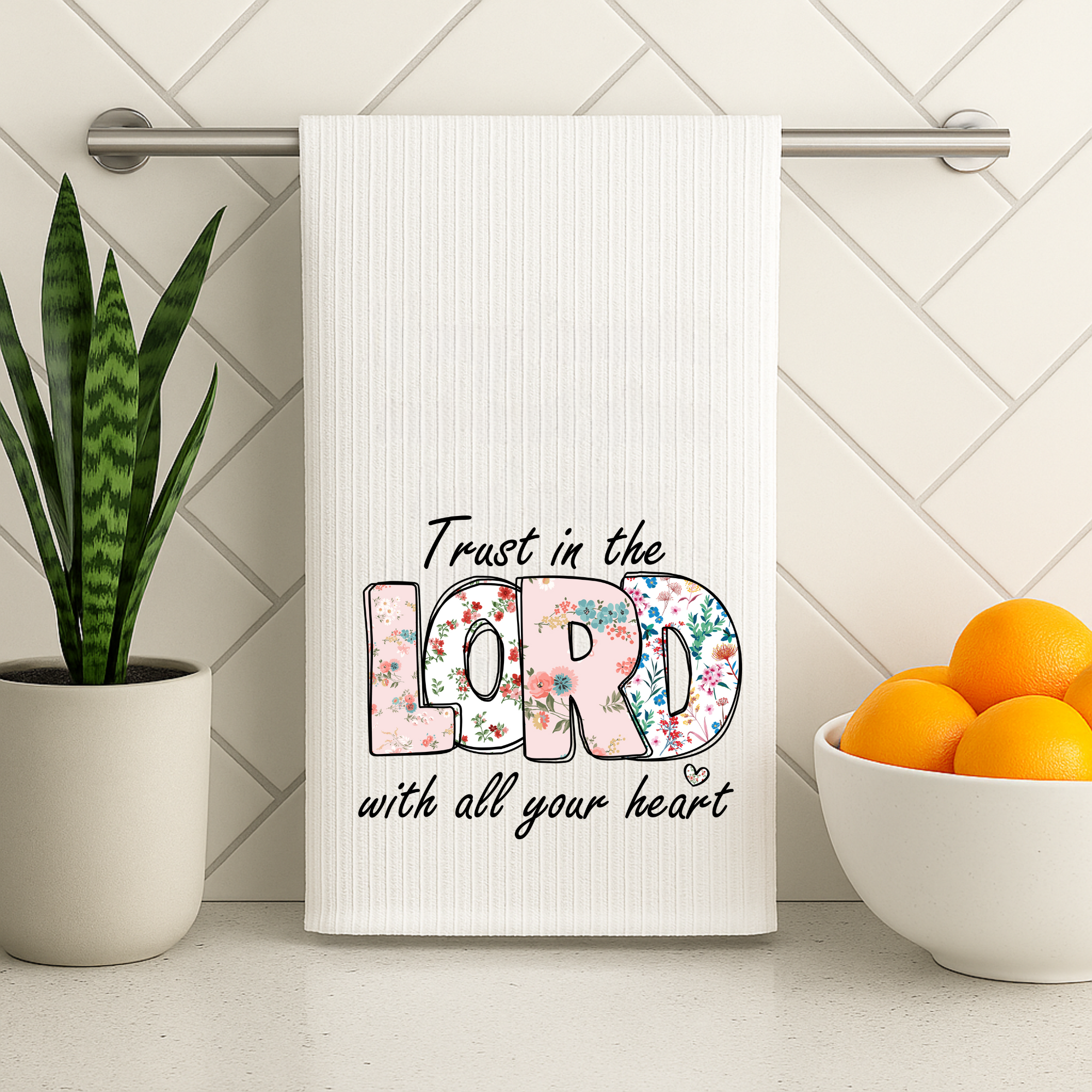 Religious kitchen decor towel with scripture message hanging on towel bar.
