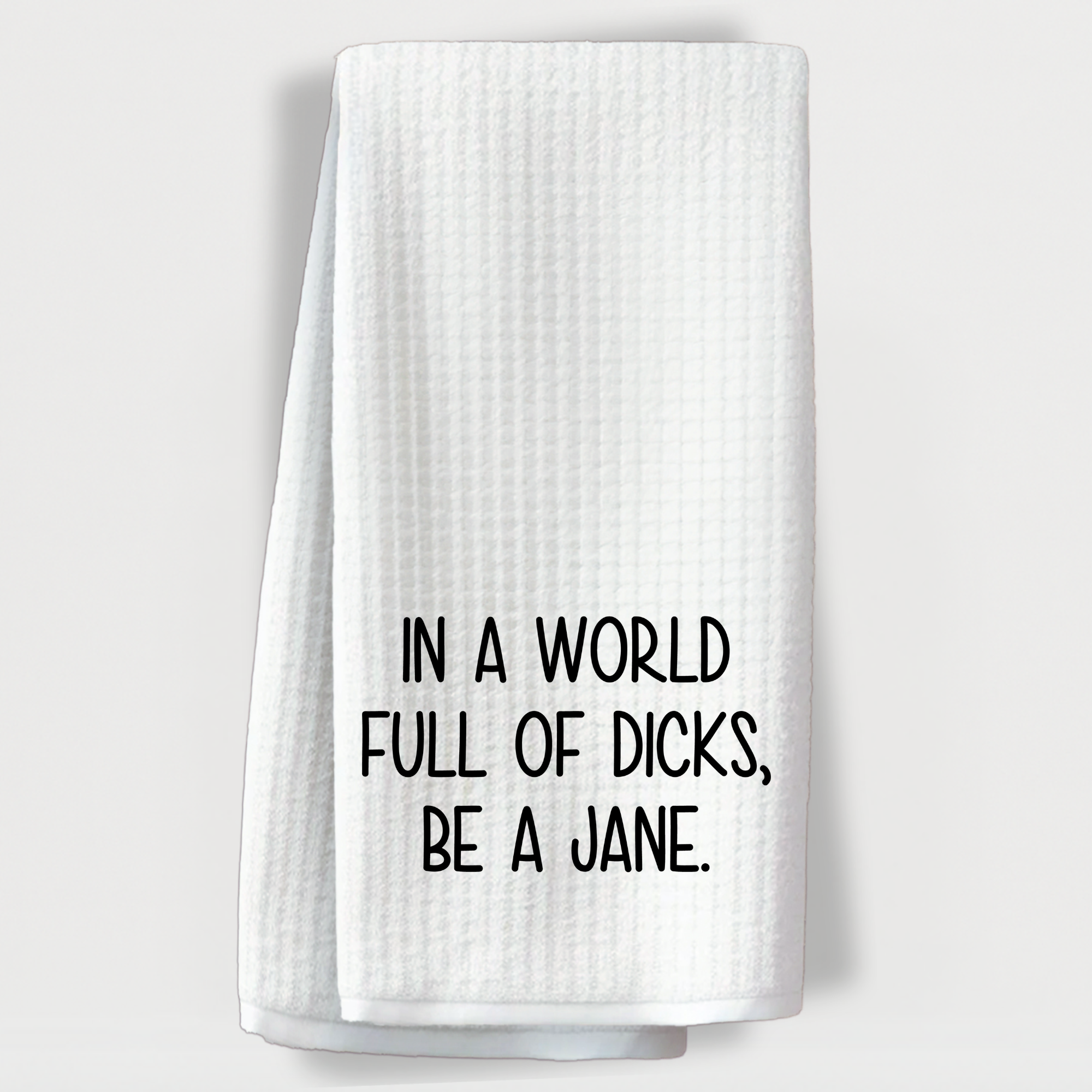 Sassy white towel with the phrase 'In a world full of dicks, be a Jane' in bold black text.