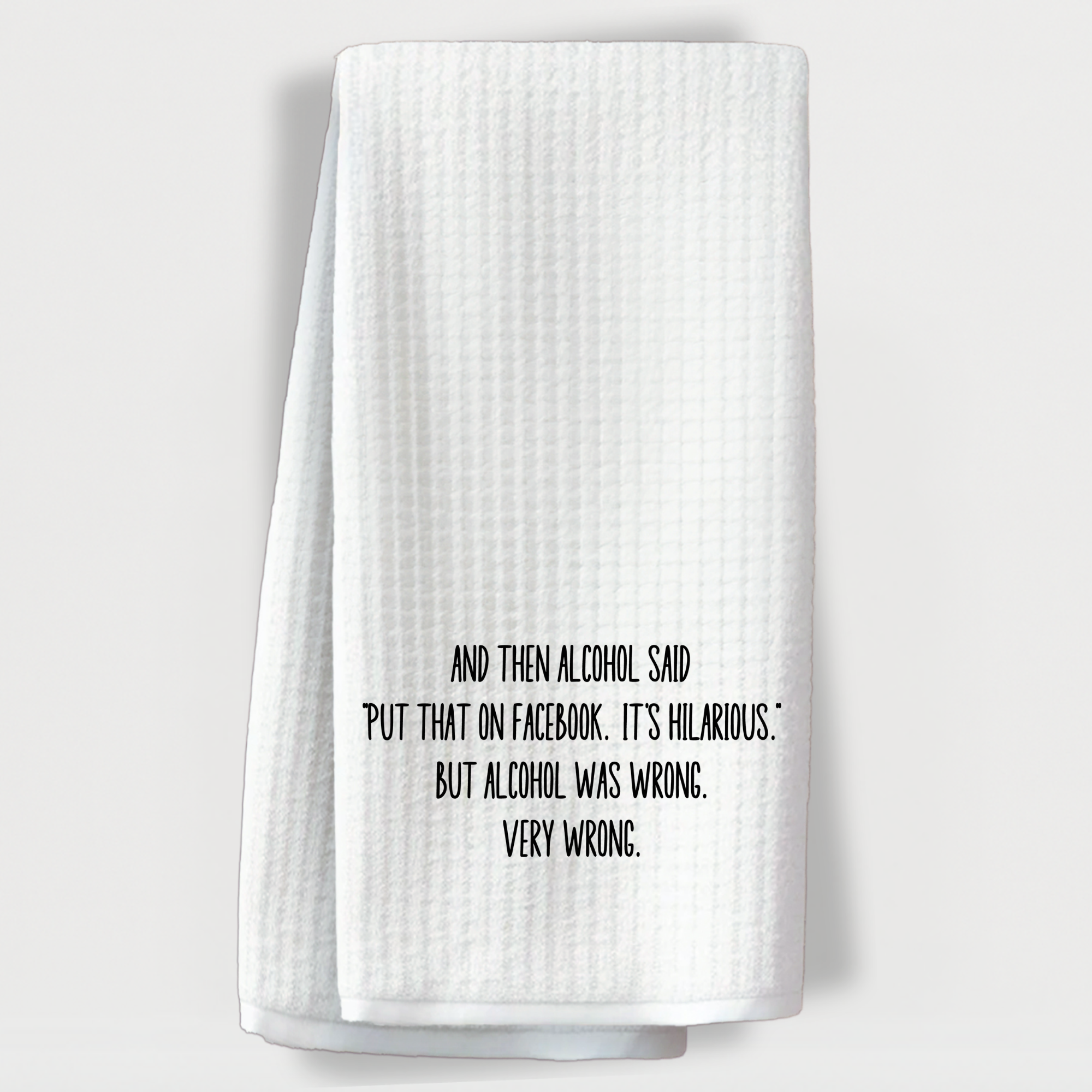 Funny kitchen towel with alcohol quote, displayed hanging on a white background – perfect for wine lovers and party hosts.