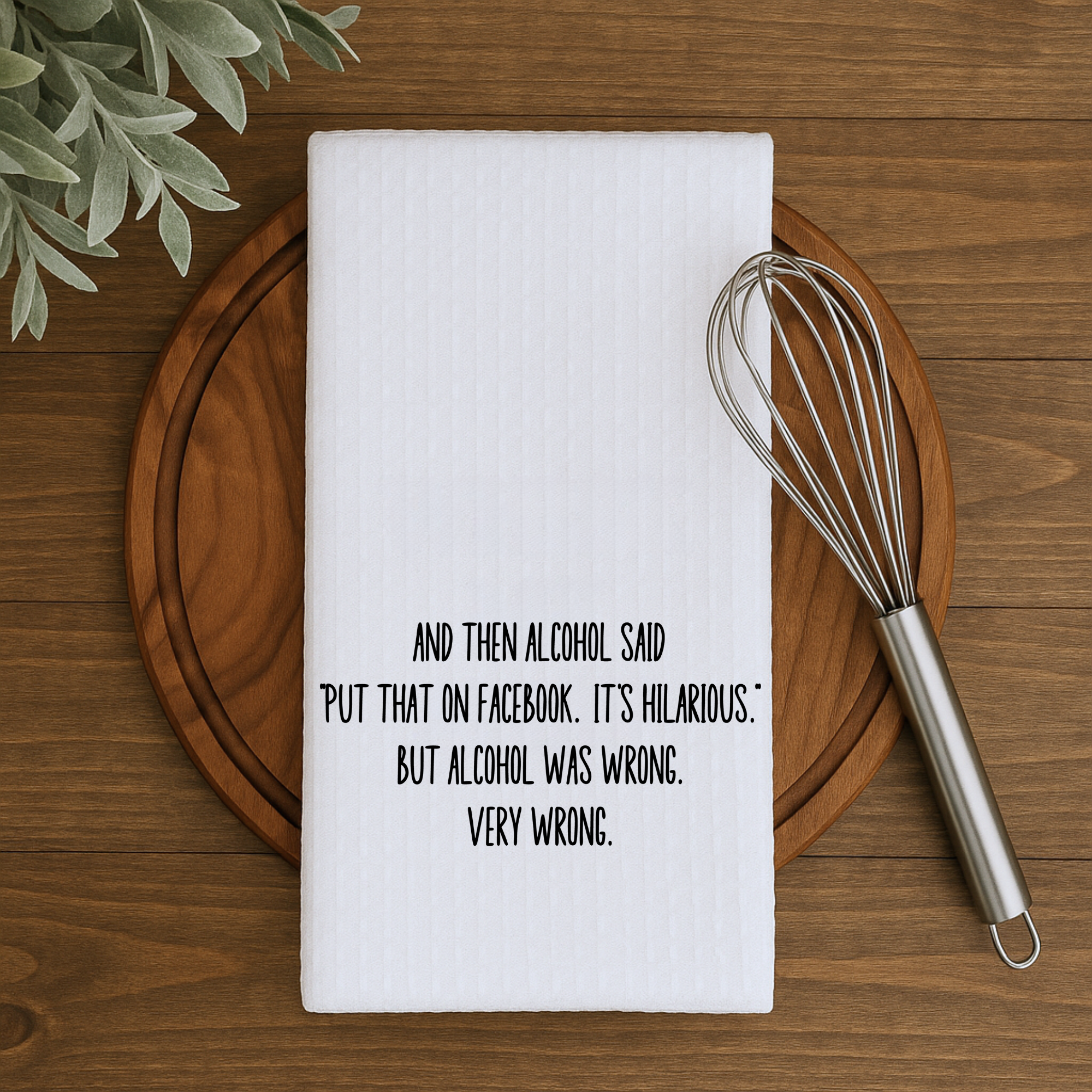 Waffle weave dish towel with witty alcohol saying, styled on a wooden cutting board with a whisk.