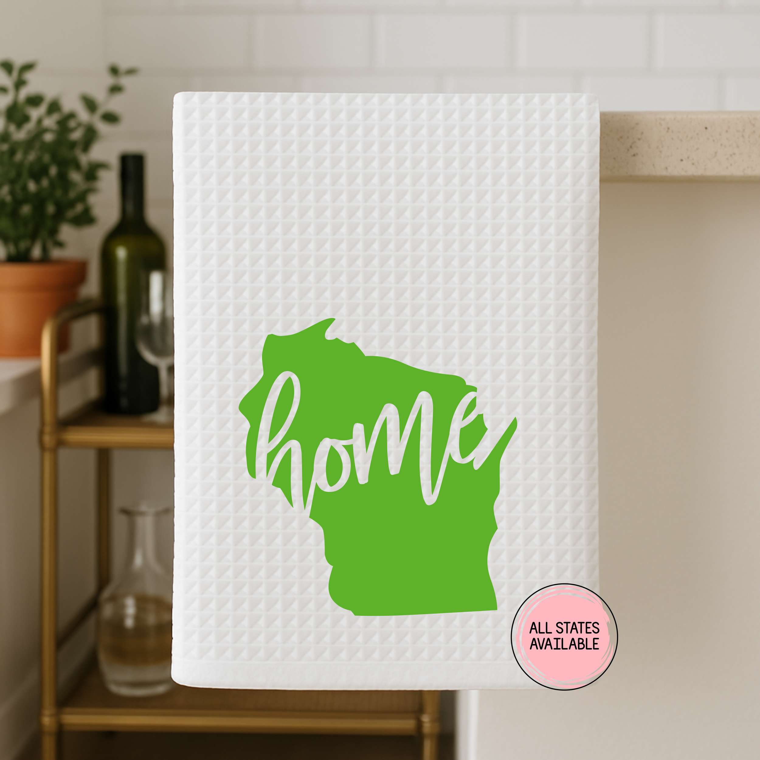 Wisconsin home state waffle weave kitchen towel with green state graphic displayed in a modern kitchen setting.