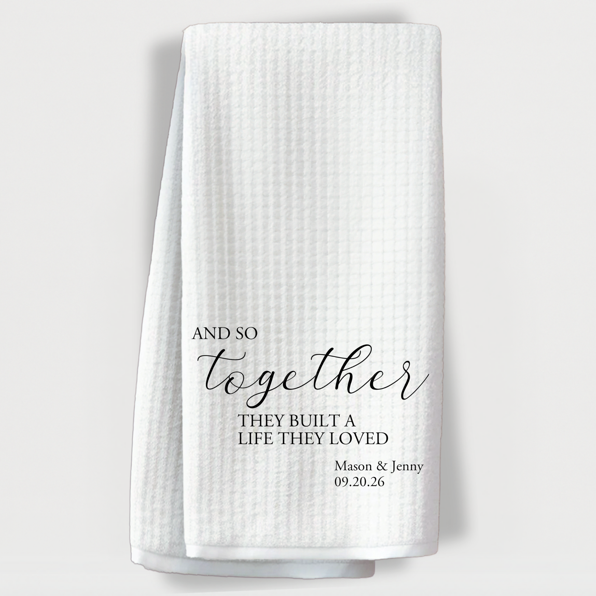 "Personalized towel with the romantic quote 'And so together they built a life they loved' and custom names and date."