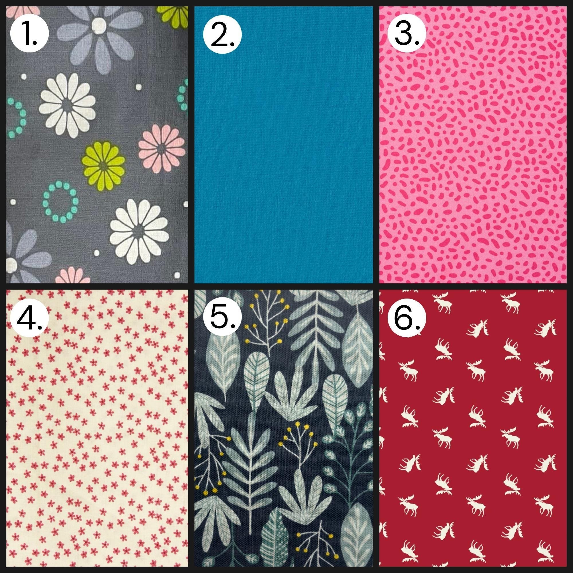 Colorful fabric patterns for crafts and sewing, including floral, solid blue, abstract pink, vintage stars, botanical leaves, and holiday moose designs.