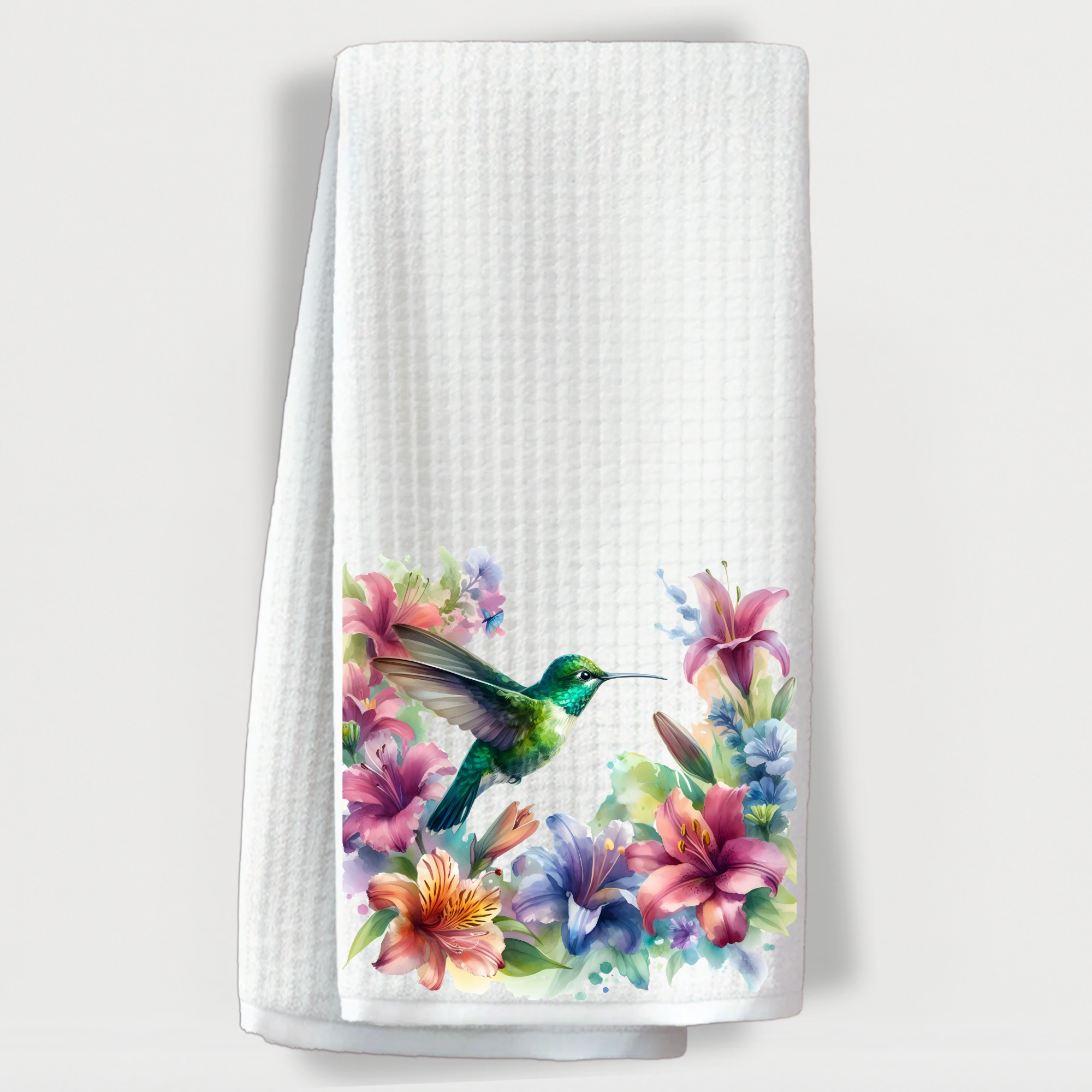"Beautiful white towel with a vibrant hummingbird hovering over colorful tropical flowers."