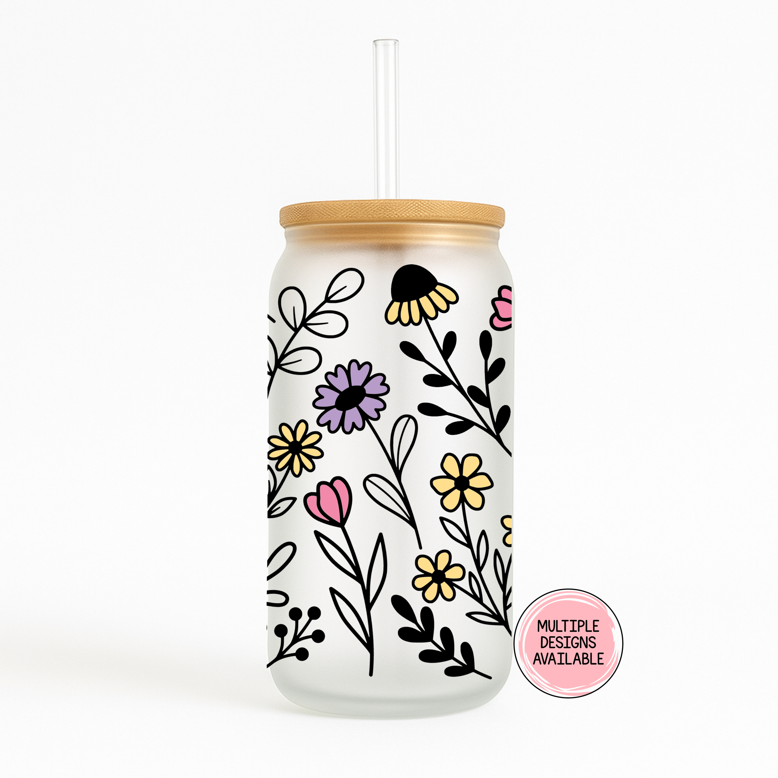 Glass tumbler featuring hand-drawn wildflowers and leaves in black, purple, yellow, and pink.