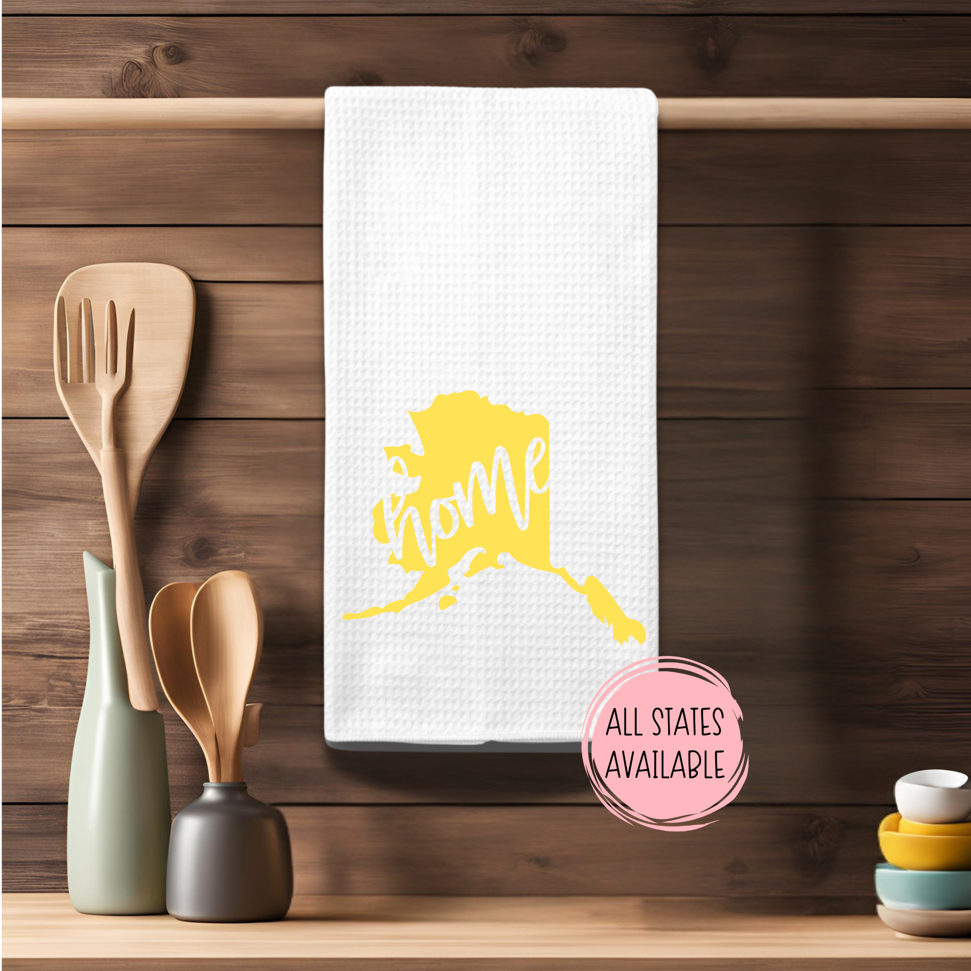 Rustic kitchen towel with yellow Alaska home state design and farmhouse wood background.