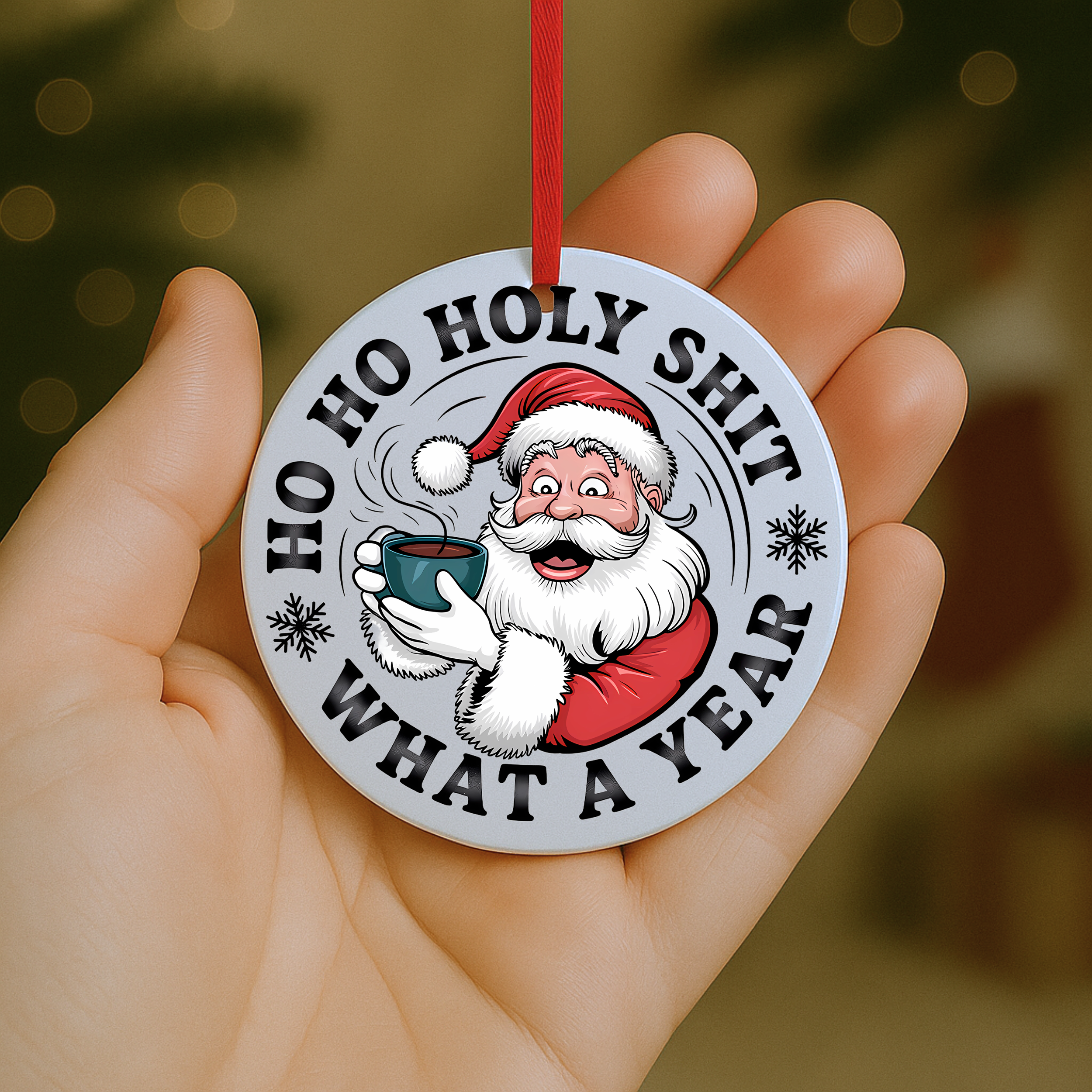 Funny Santa Christmas ornament reading “Ho Ho Holy Shit What a Year,” shown held in hand with red ribbon.