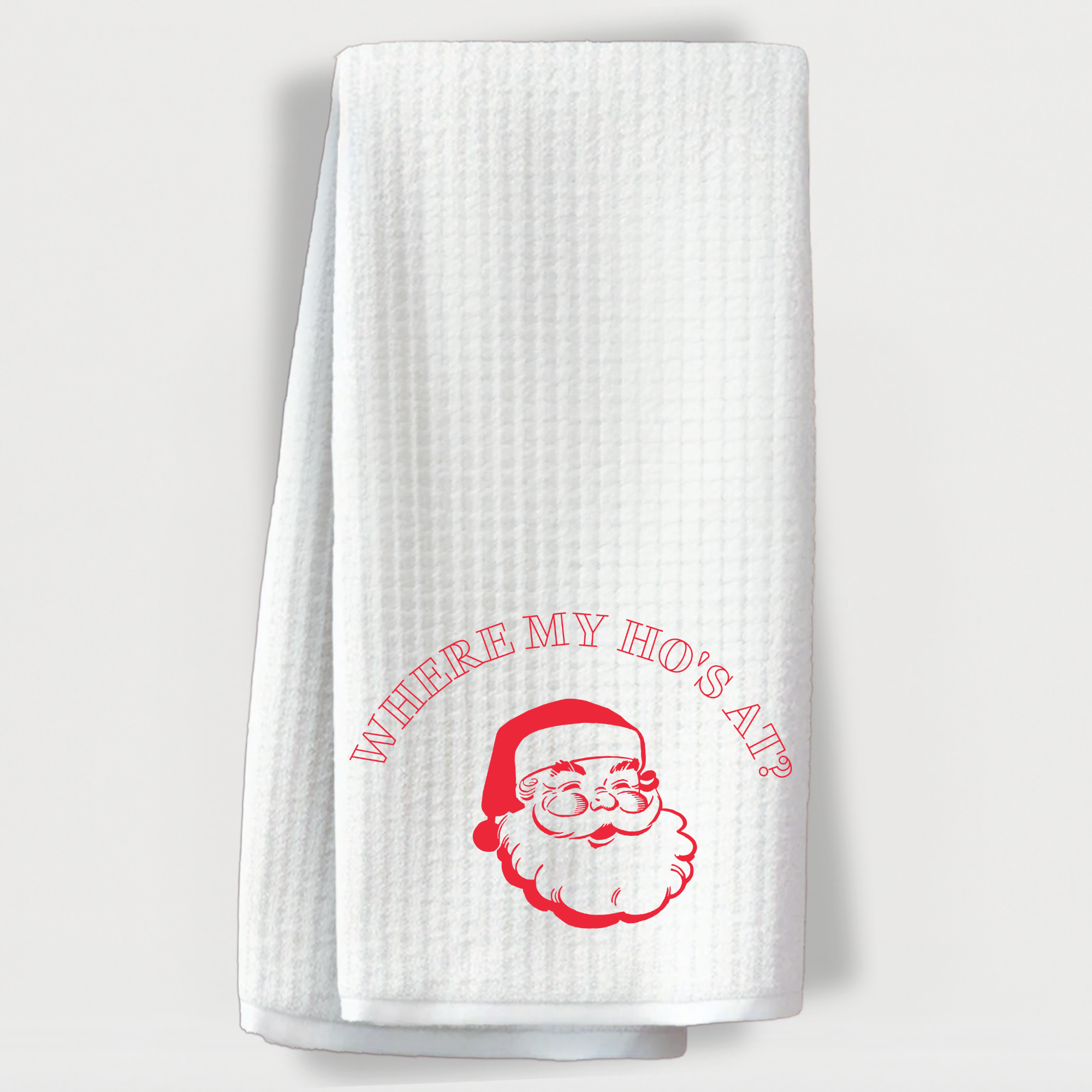 White kitchen towel with bold red Santa and cheeky “Where My Ho’s At?” holiday quote.