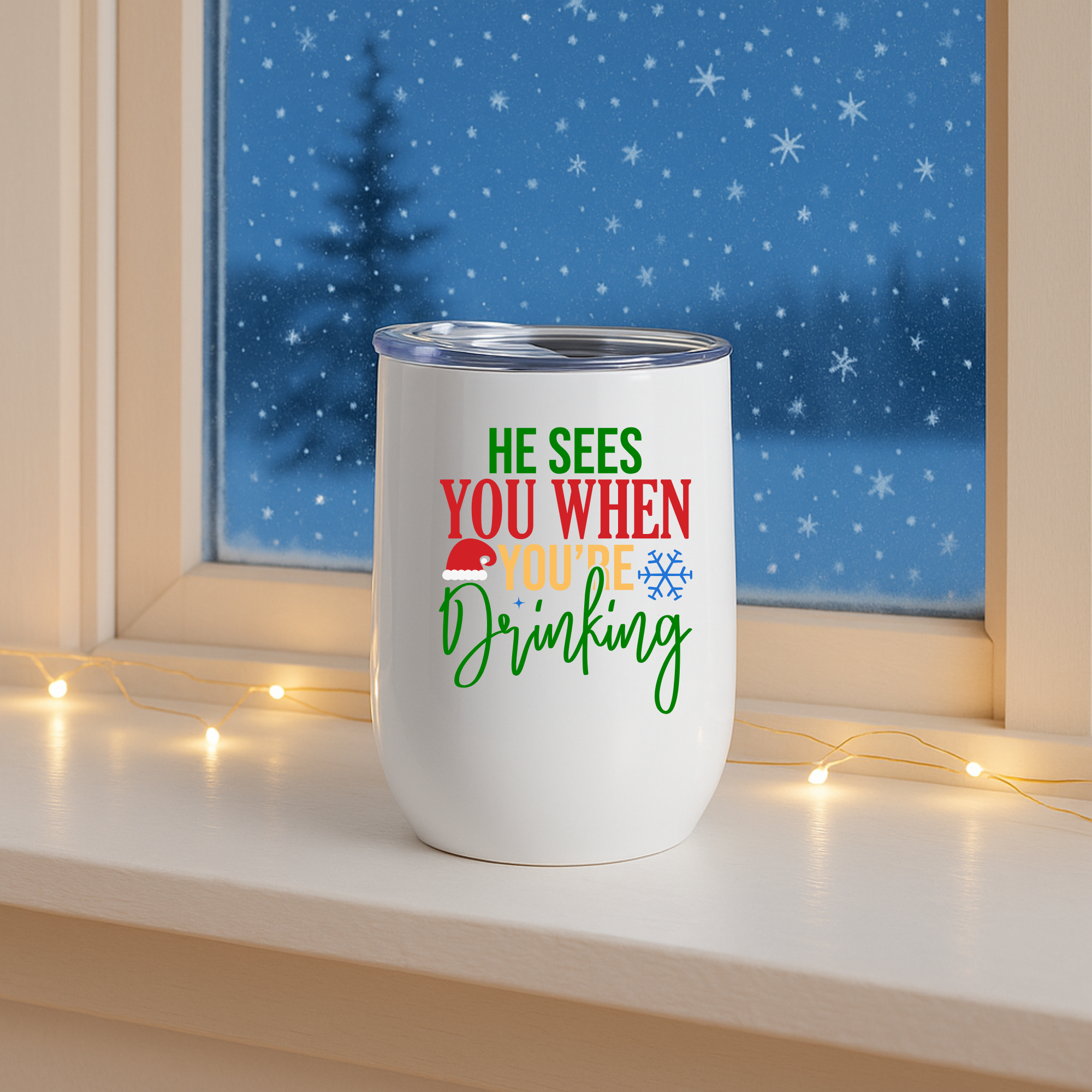 Christmas tumbler displayed on windowsill at night with snow falling outside and festive lights.
