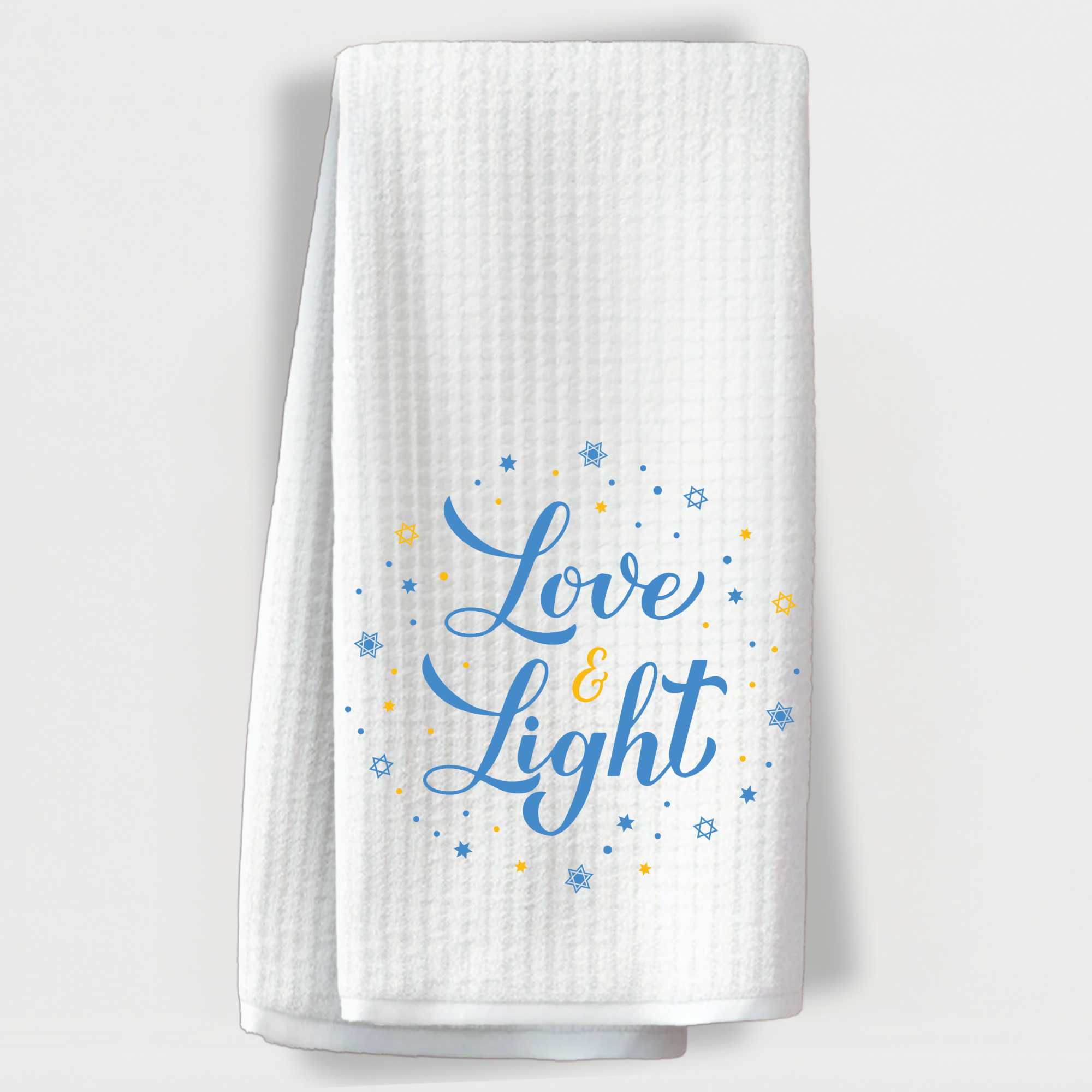 "Hanukkah-themed towel with 'Love & Light' in blue and yellow surrounded by stars of David."