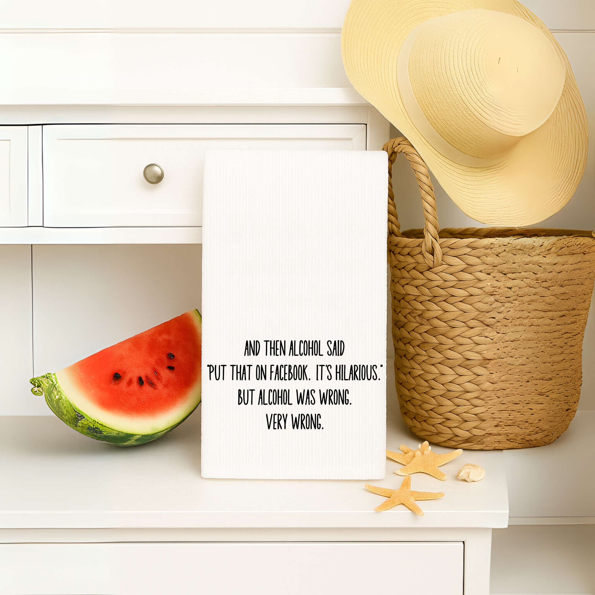 Sassy dish towel with alcohol Facebook quote, displayed with a beach bag, hat, and watermelon – ideal for summer gifts.