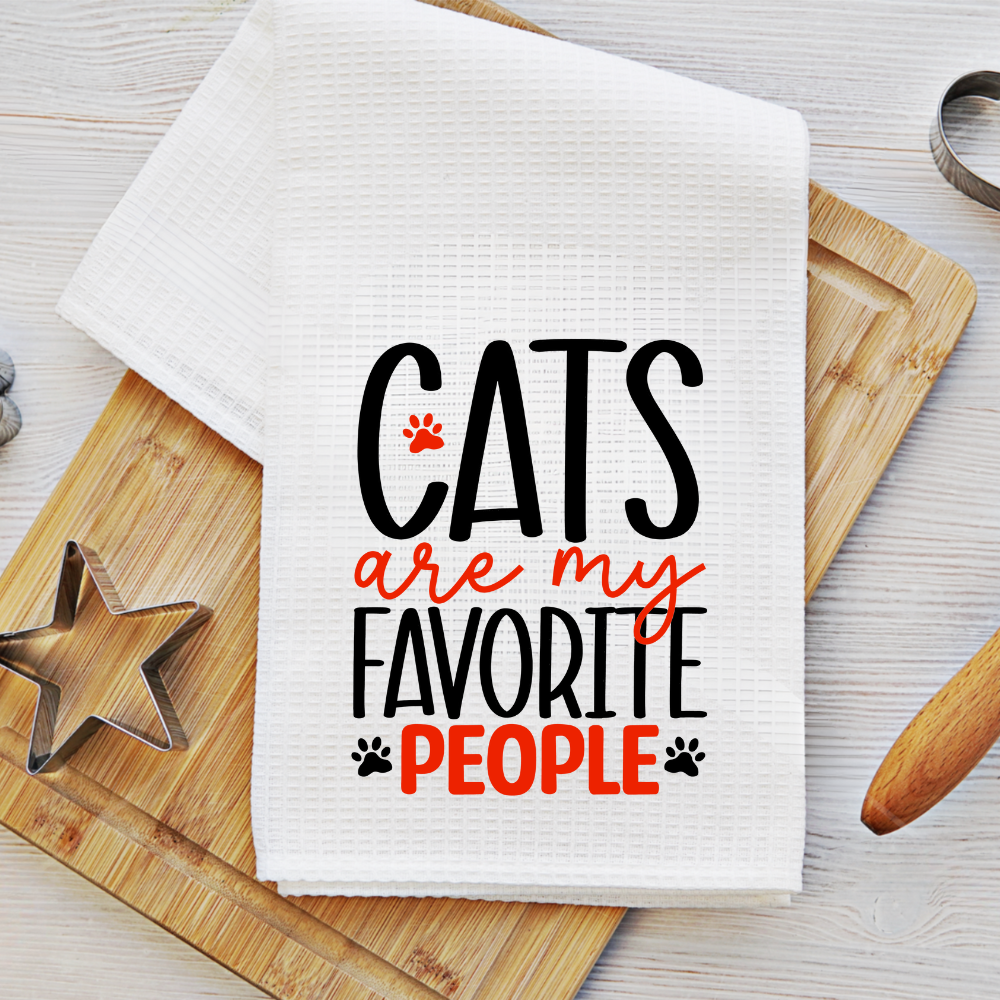 Soft microfiber dish towel with a cat-inspired quote, styled on a wooden cutting board with cookie cutters, great for baking lovers.