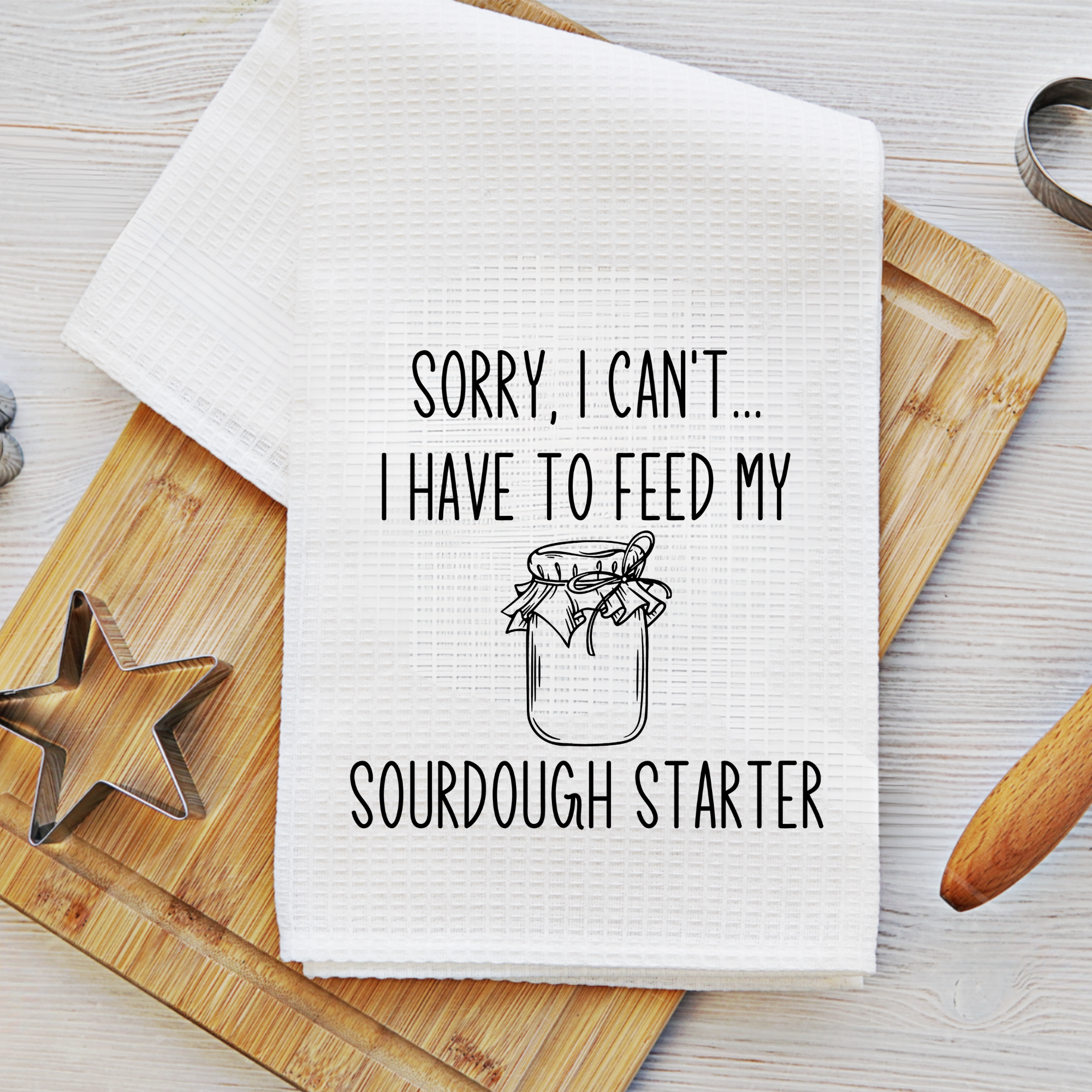 Funny baking towel styled with cookie cutter and rolling pin – perfect housewarming or foodie gift.
