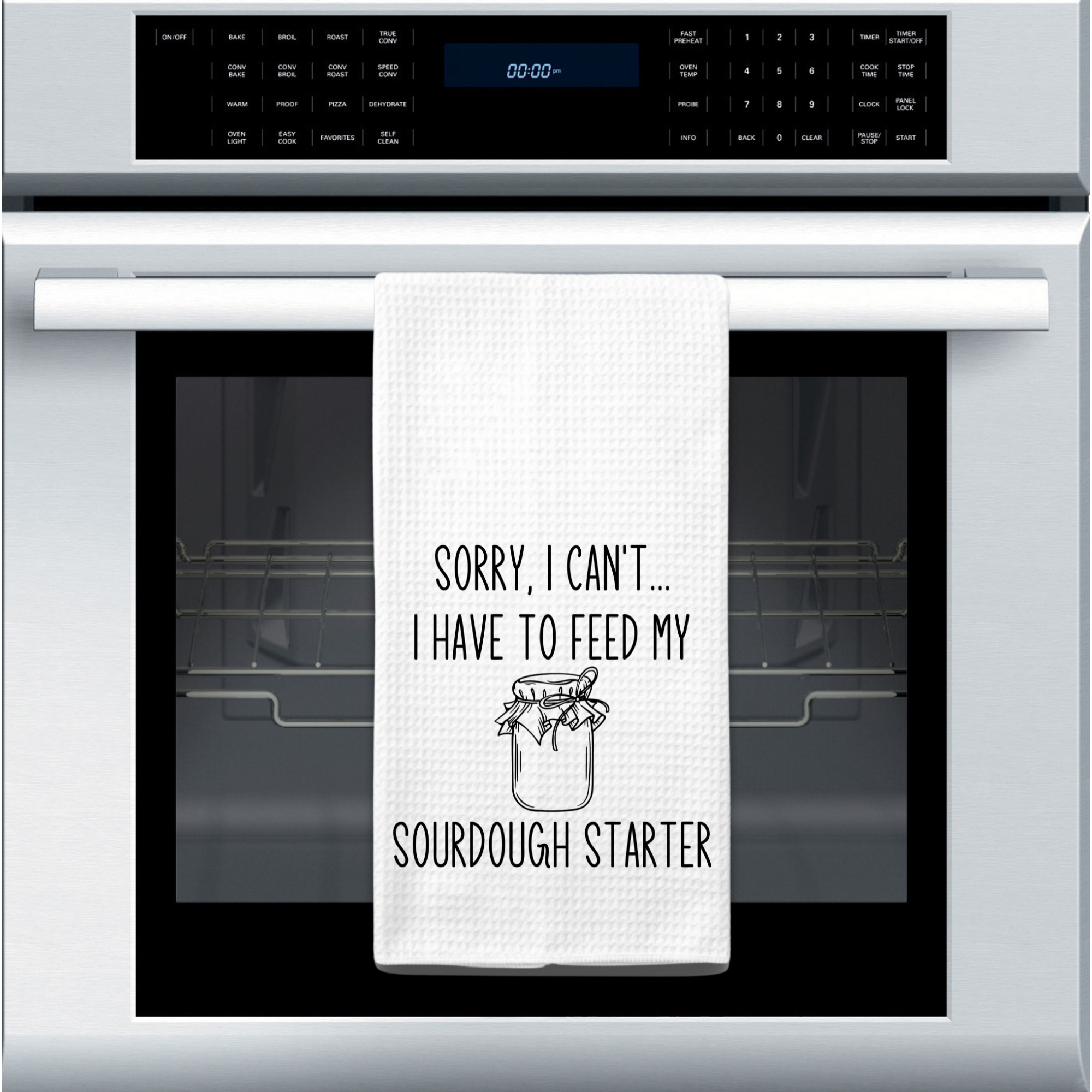Sourdough starter kitchen towel displayed on stainless steel oven – funny gift for introverted bakers.