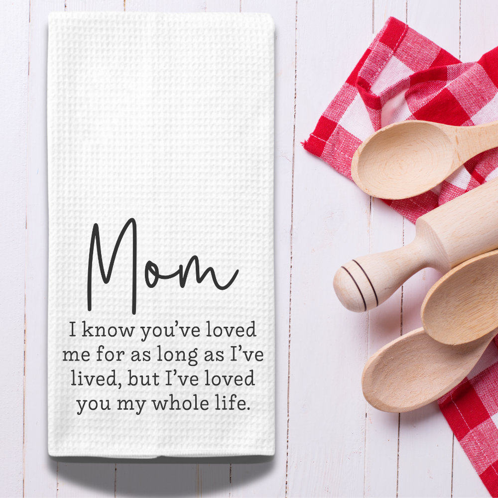 White decorative dish towel with a sentimental message, styled with red gingham napkins and wooden spoons. A perfect farmhouse kitchen gift. (Copy)