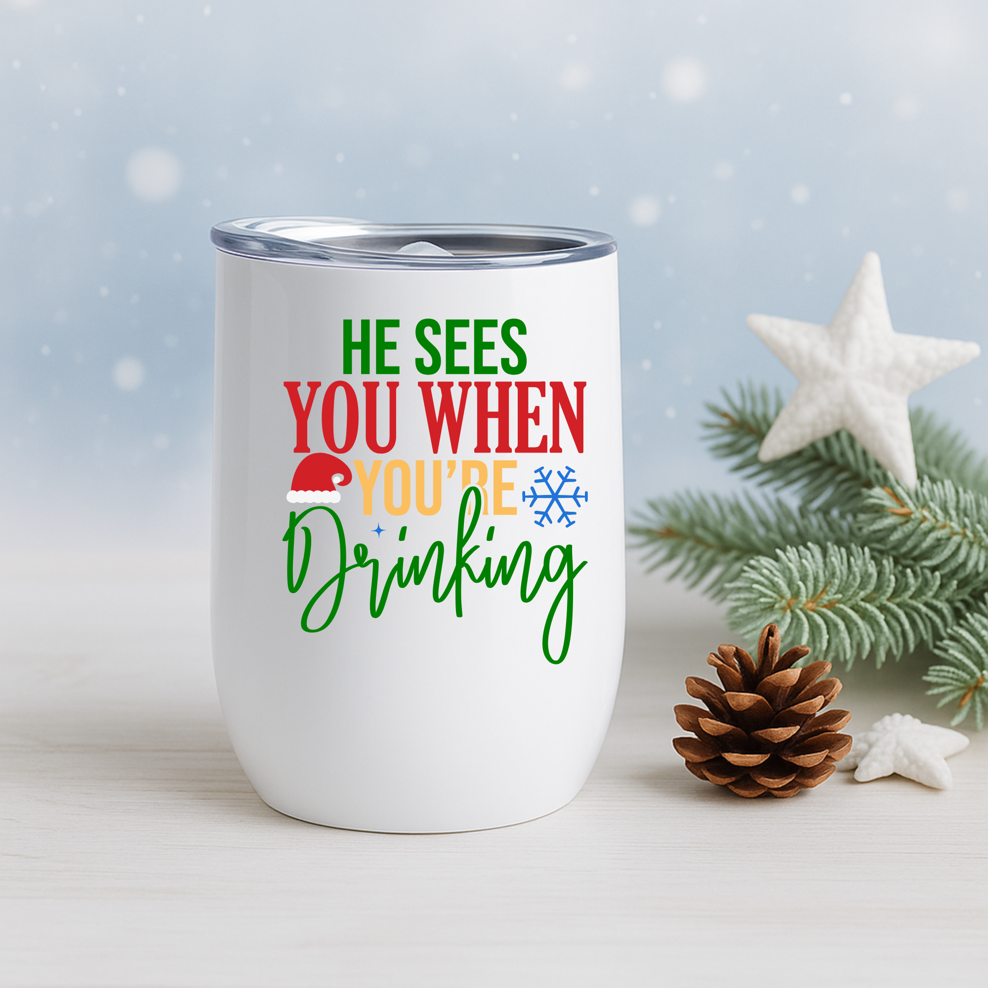 Holiday tumbler with funny drinking quote positioned beside pine branches, pinecone, and star decor.