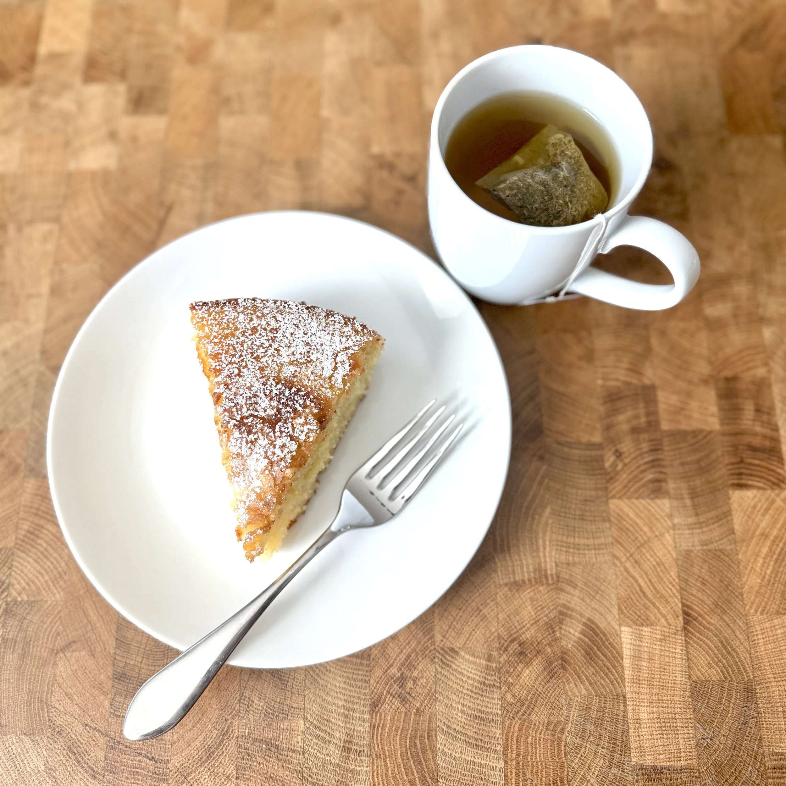 Lemon olive oil cake slice with cup of tea.jpg