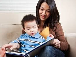 Mother promoting early childhood literacy and relational connection through shared reading and dyadic support.
