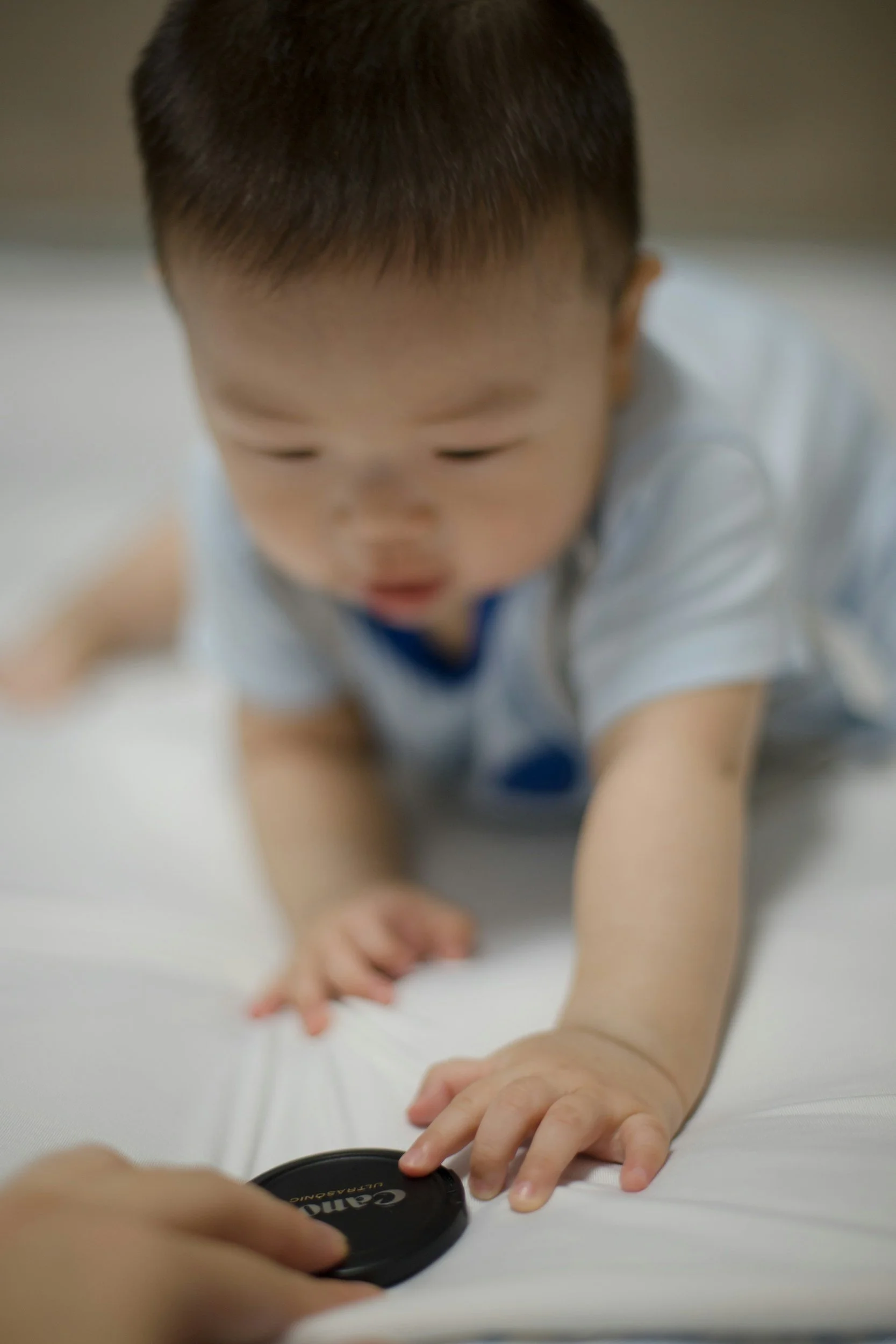 Close-up of a young child crawling reaching developmental milestones