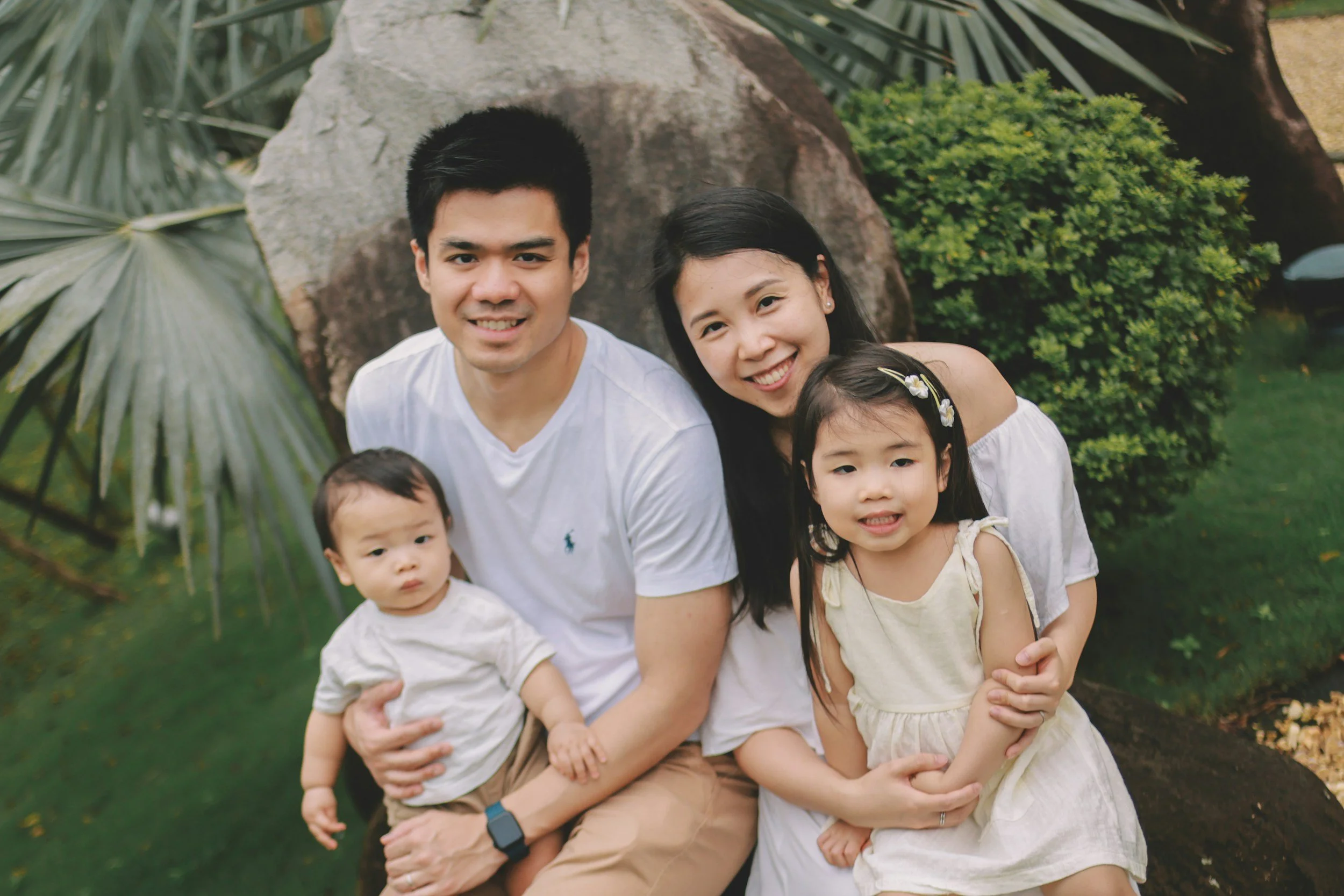 A family of four smiling together, representing grounded resilience after the identity earthquake.