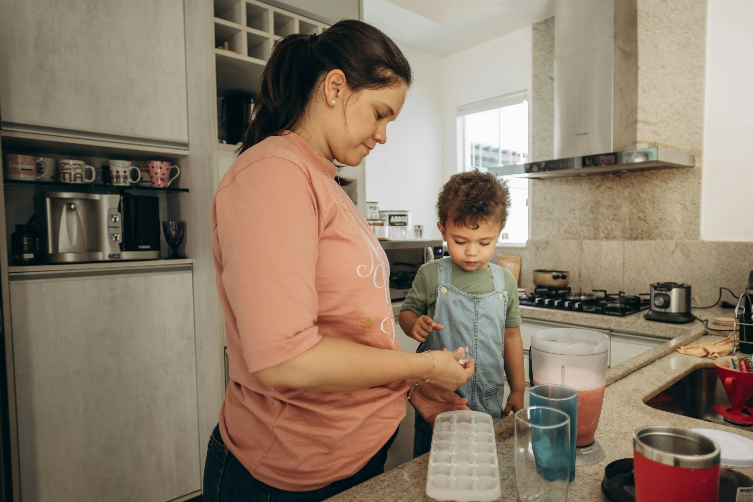 Mother and toddler working together to make a drink, practicing co-regulation.