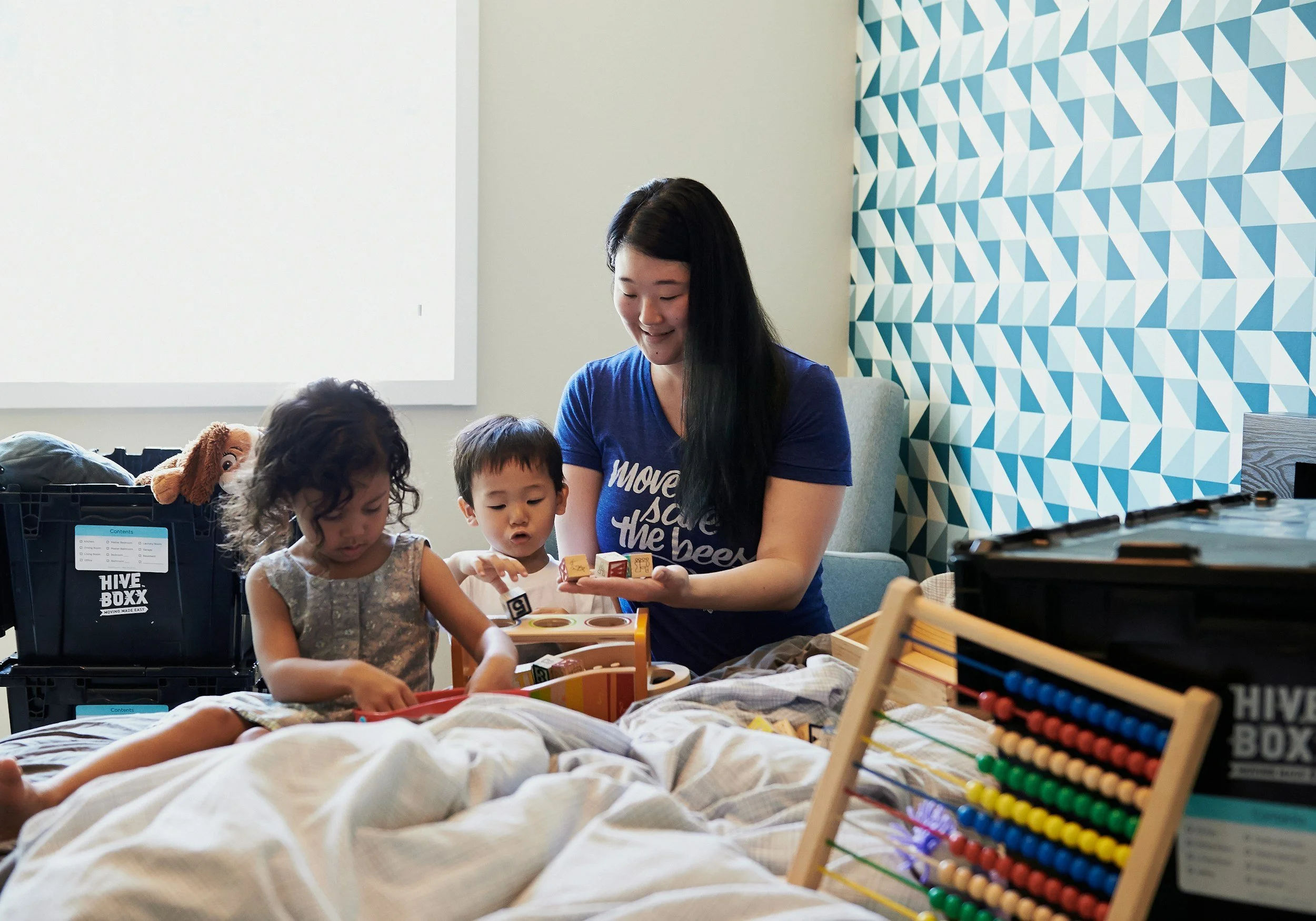 bedtime-routine.jpg	Mother and toddlers playing with toys on a bed, reinforcing secure family attachment.