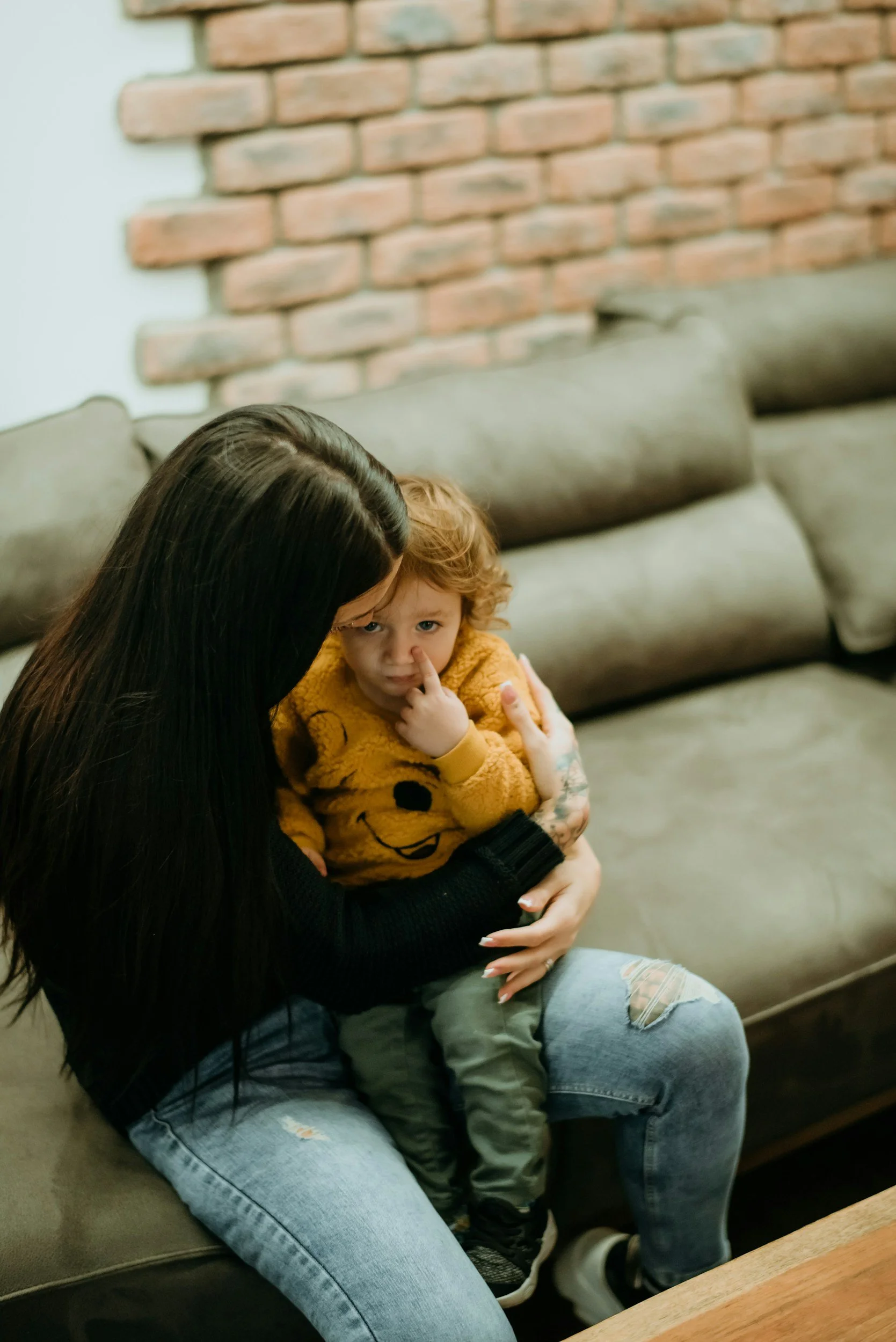 Mother hugging a toddler to facilitate repair and reconnection after a period of distress.