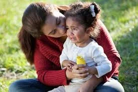 A mother using somatic grounding and co-regulation to soothe a toddler’s big feelings and tantrums.