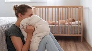 rage-somatic-release.jpg	Mother screaming into a pillow while baby sleeps, illustrating hyper-arousal.