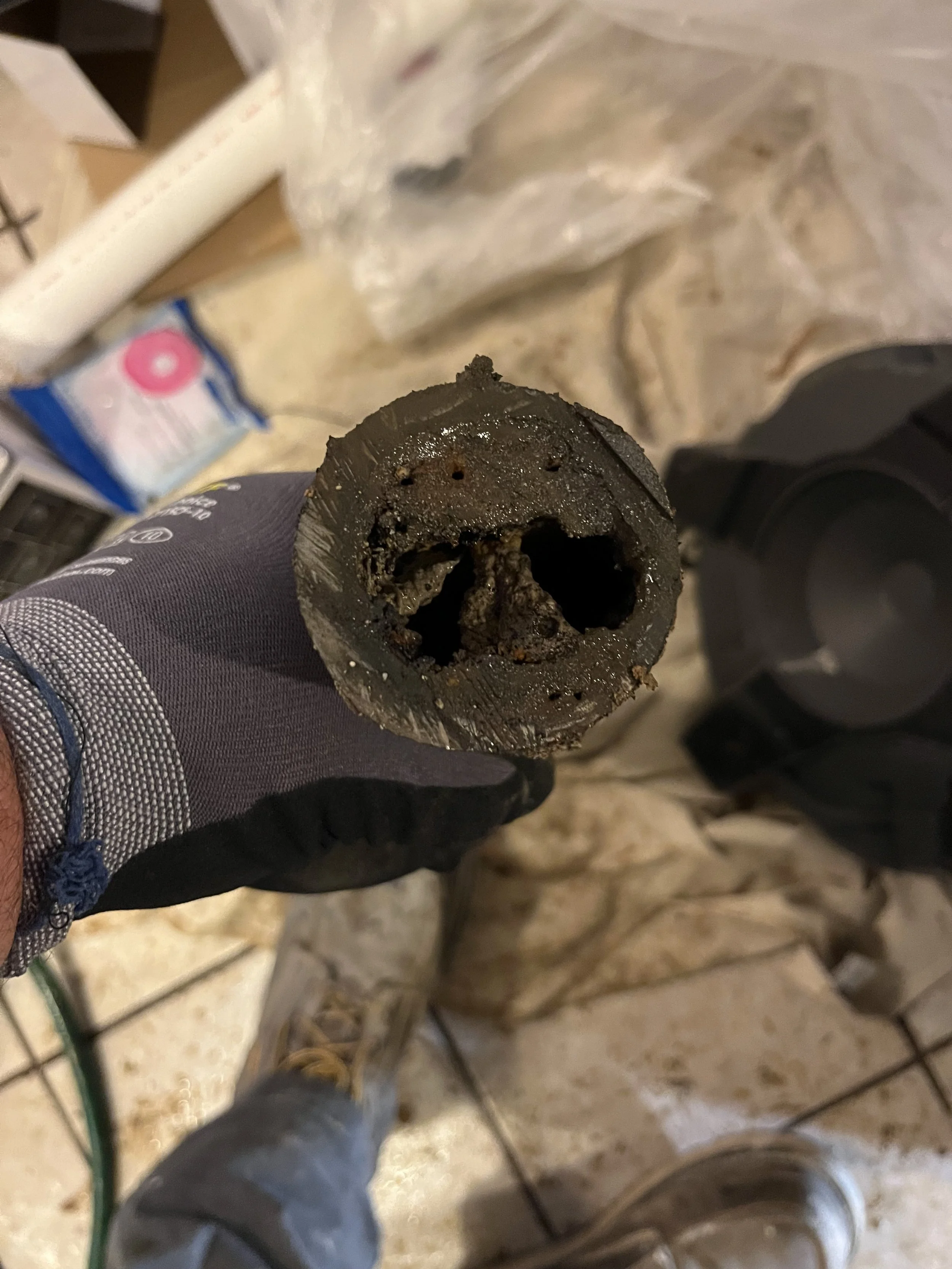 Close-up of a dirty, used firework fuse with blackened corroded material.