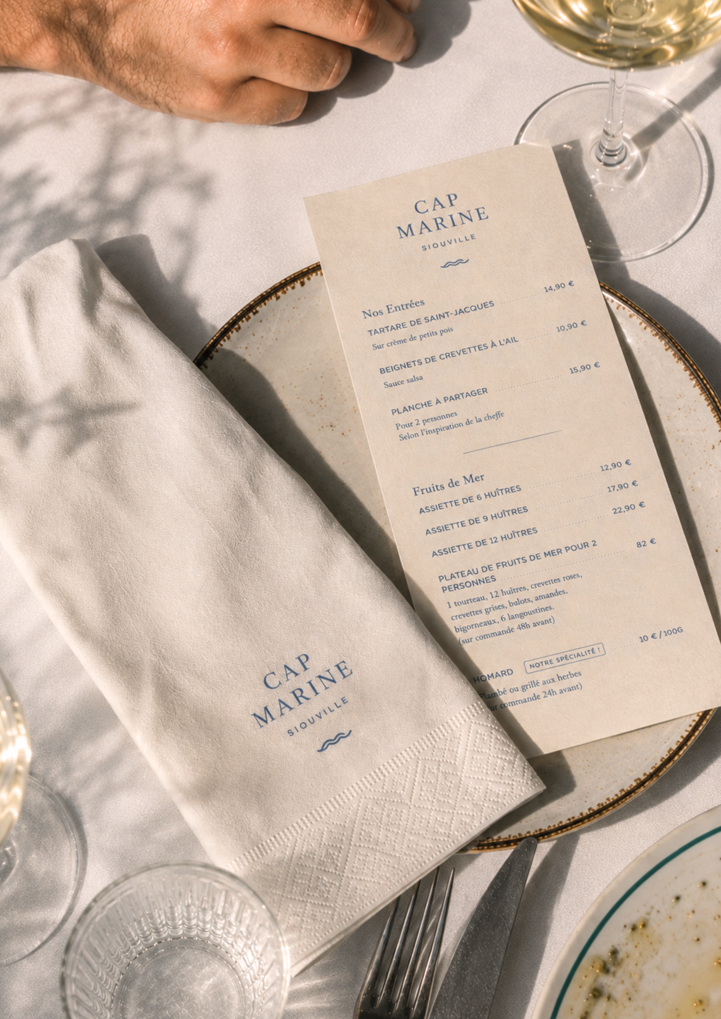Cap Marine restaurant menu and table setting in Siouville, Normandy, photographed in natural coastal light.