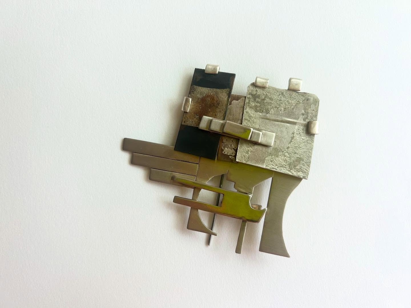Mixed metal brooch. Oxidized nickel and silver scrap metals.