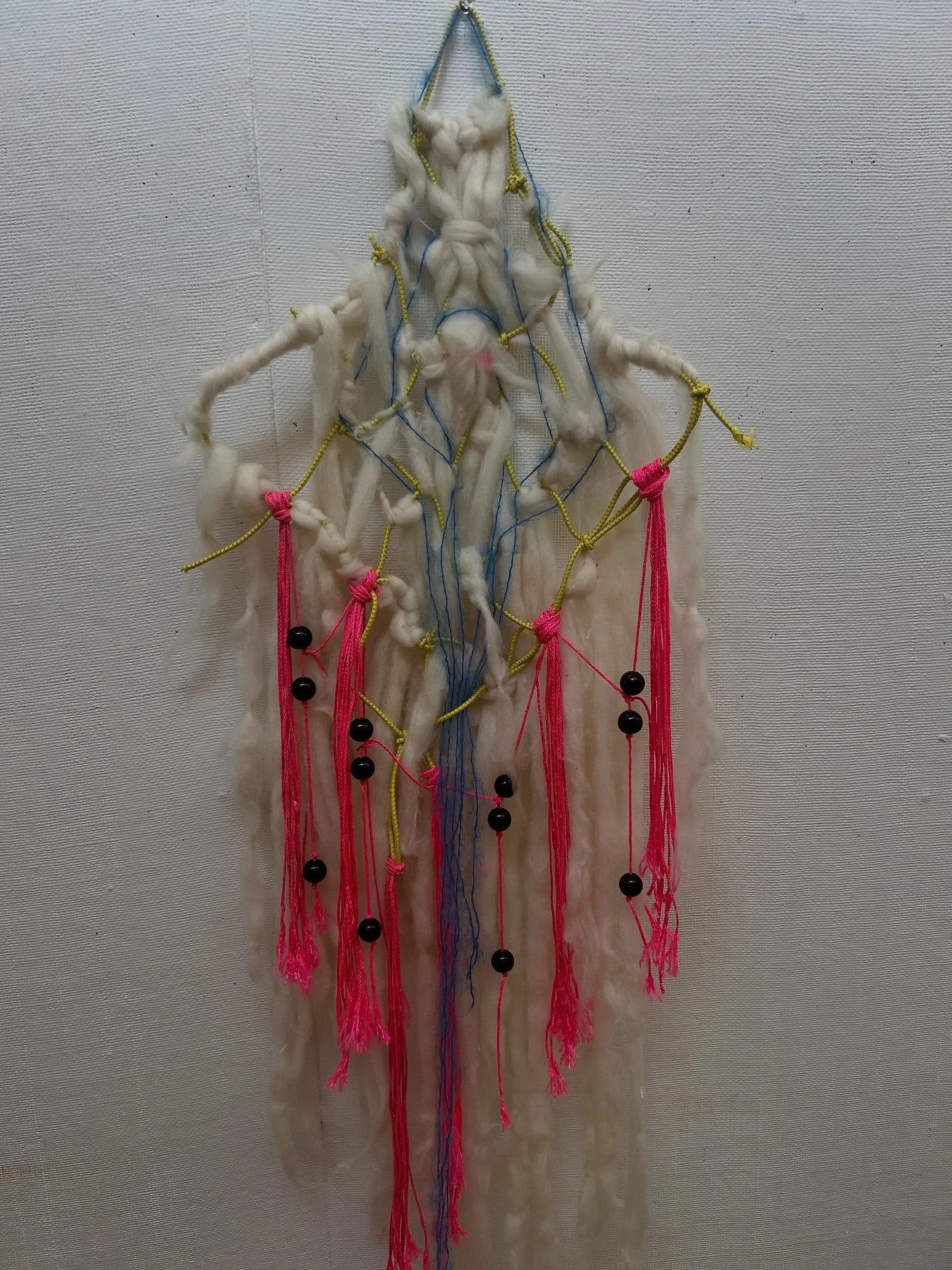some whimsical ass thing I made. wool string beads and bungee cords