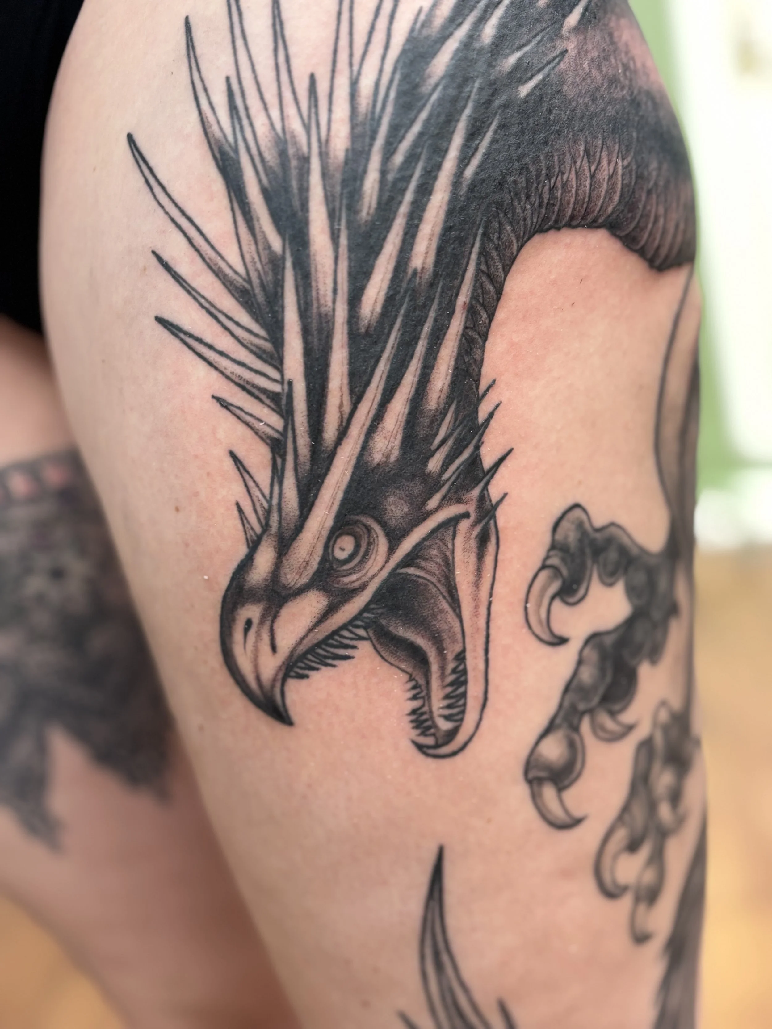 Tattoo of a Hungarian Horntail dragon from the Harry Potter universe, with detailed scales and an open maw.