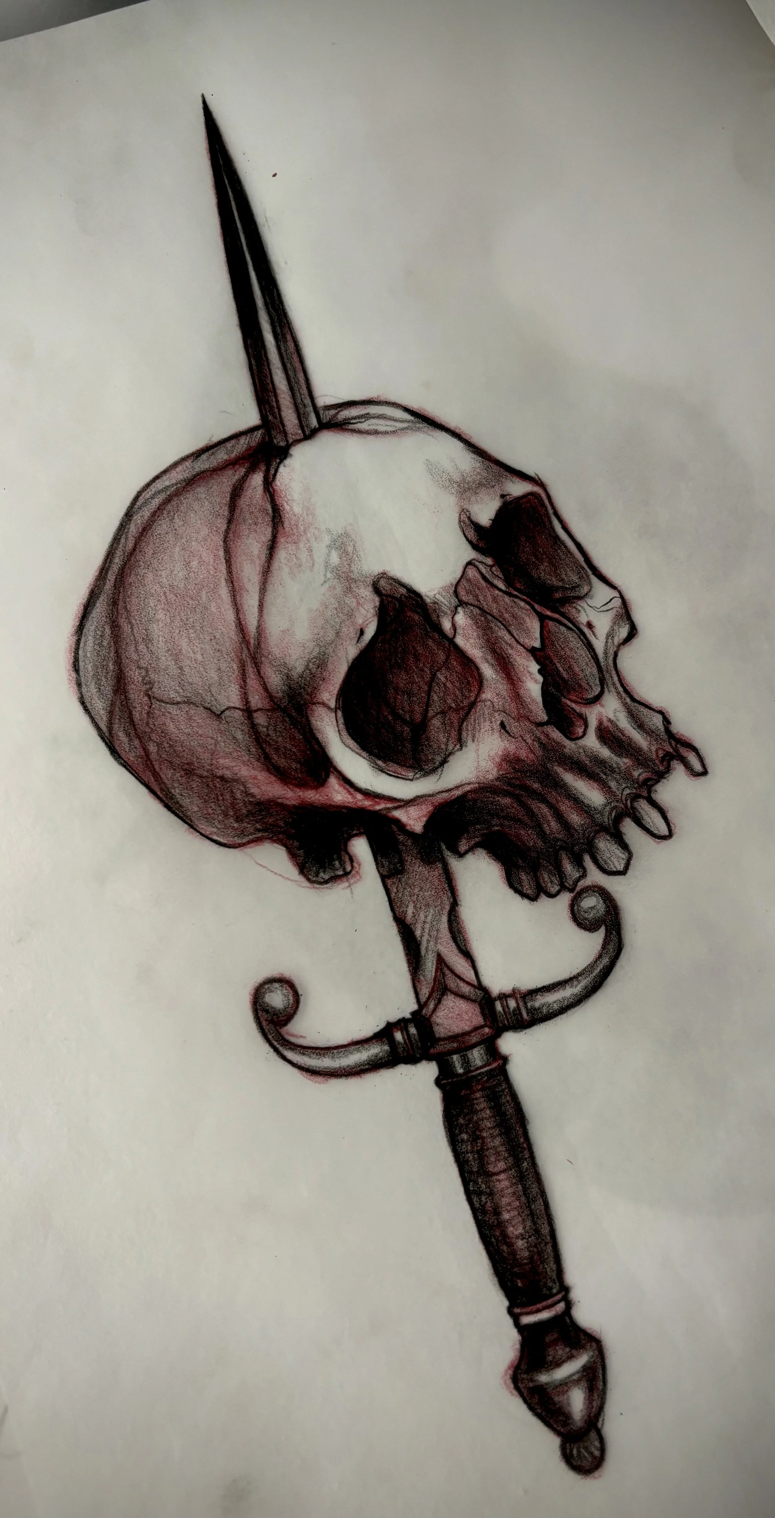 A detailed drawing of a skull with a dagger piercing through it, featuring a decorative handle.