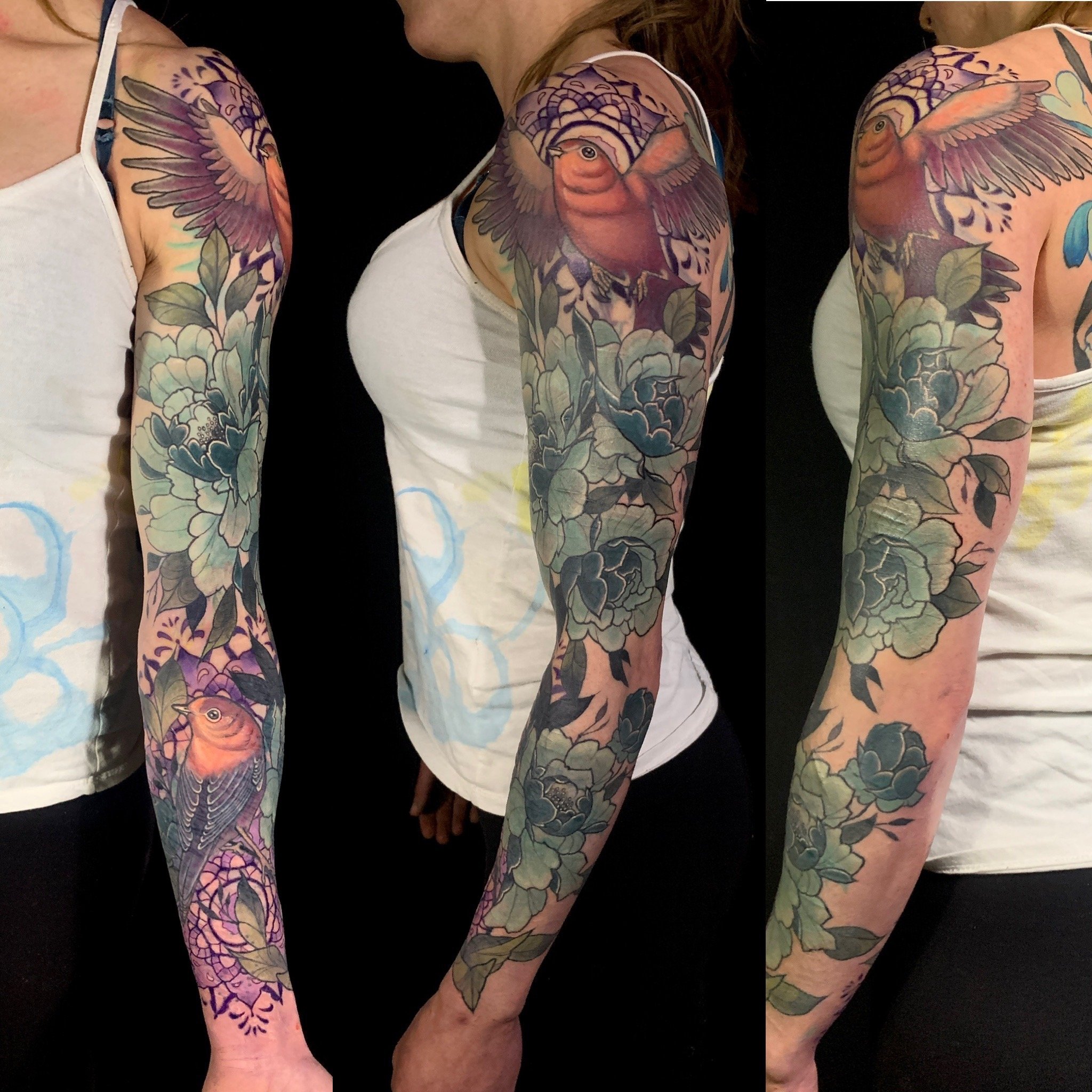A woman with colorful floral and bird tattoos on her arm, wearing a white tank top and black pants, photographed from three different angles against a black background.
