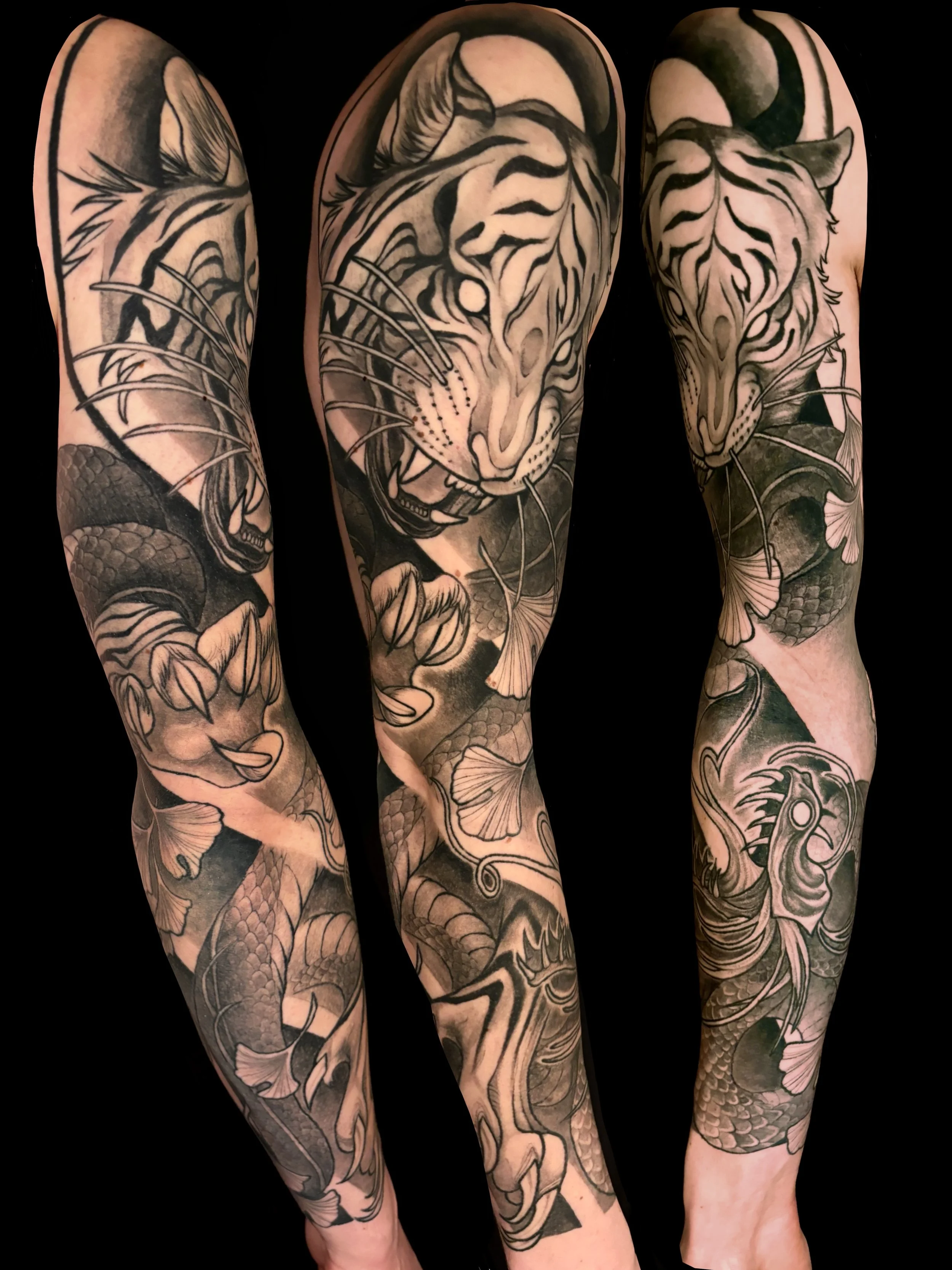 Black and gray tattoo sleeve featuring a tiger, snake, and gingko elements.