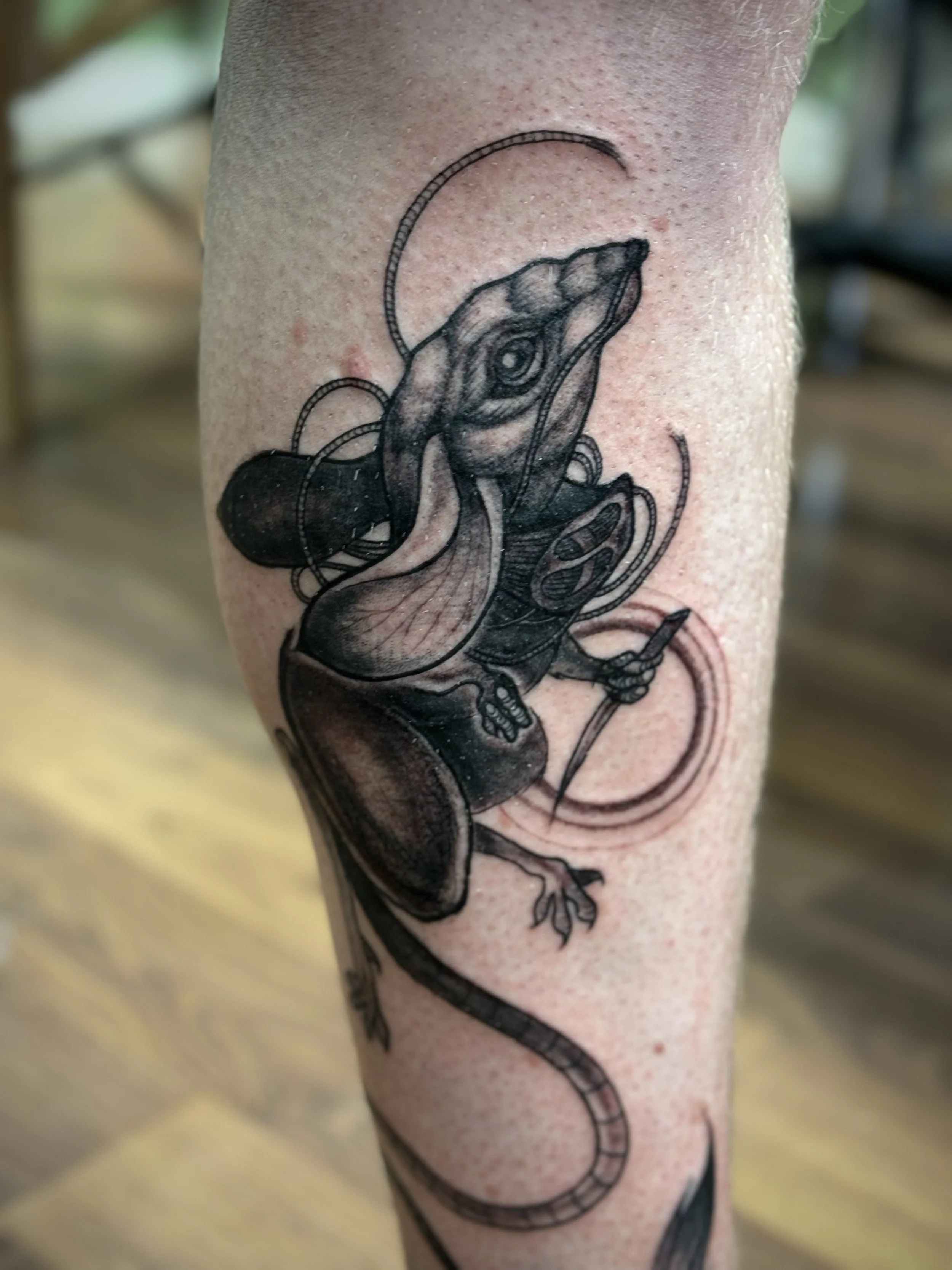 A tattoo of a kangaroo mouse wearing a still suit mask from Dune. Muad'Dib tattoo.