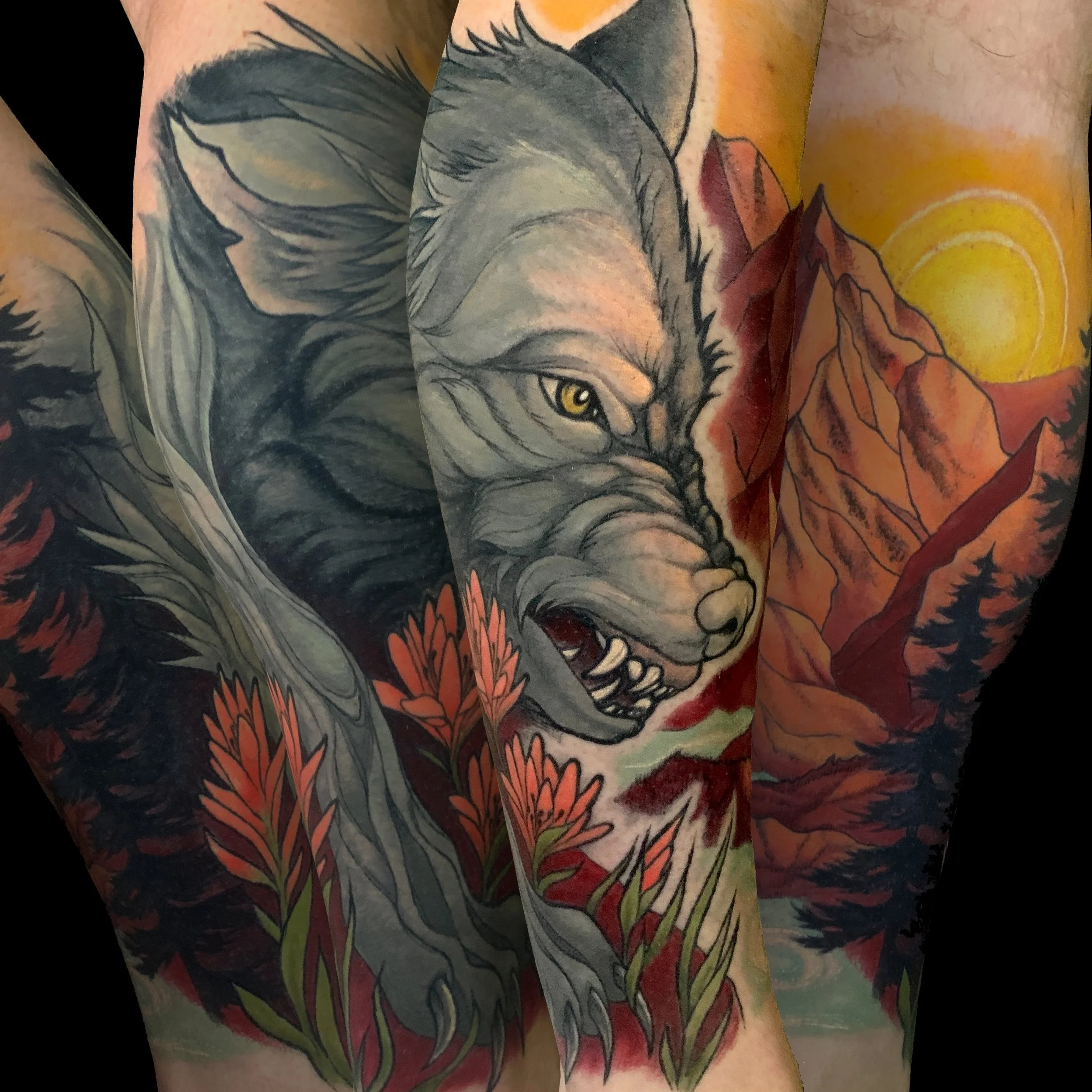 Tattoo of a wolf with yellow eyes, surrounded by red flowers, on a person's arm.