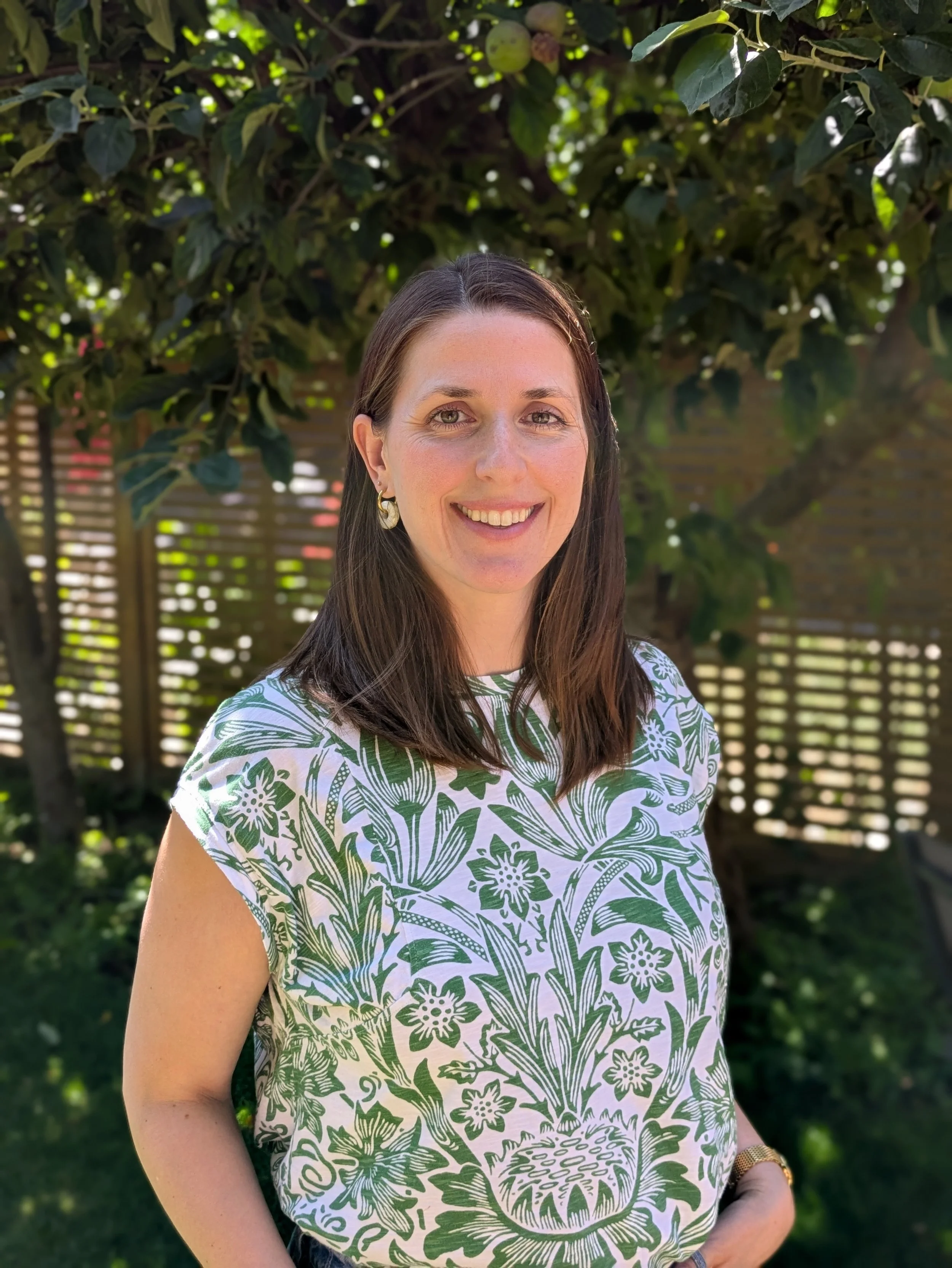 Whirl & Wonder's certified Antenatal and Postnatal Coach, smiling in a lush garden setting. Ready to support second-time parents in Walthamstow through expert Antenatal Classes and Postnatal support.