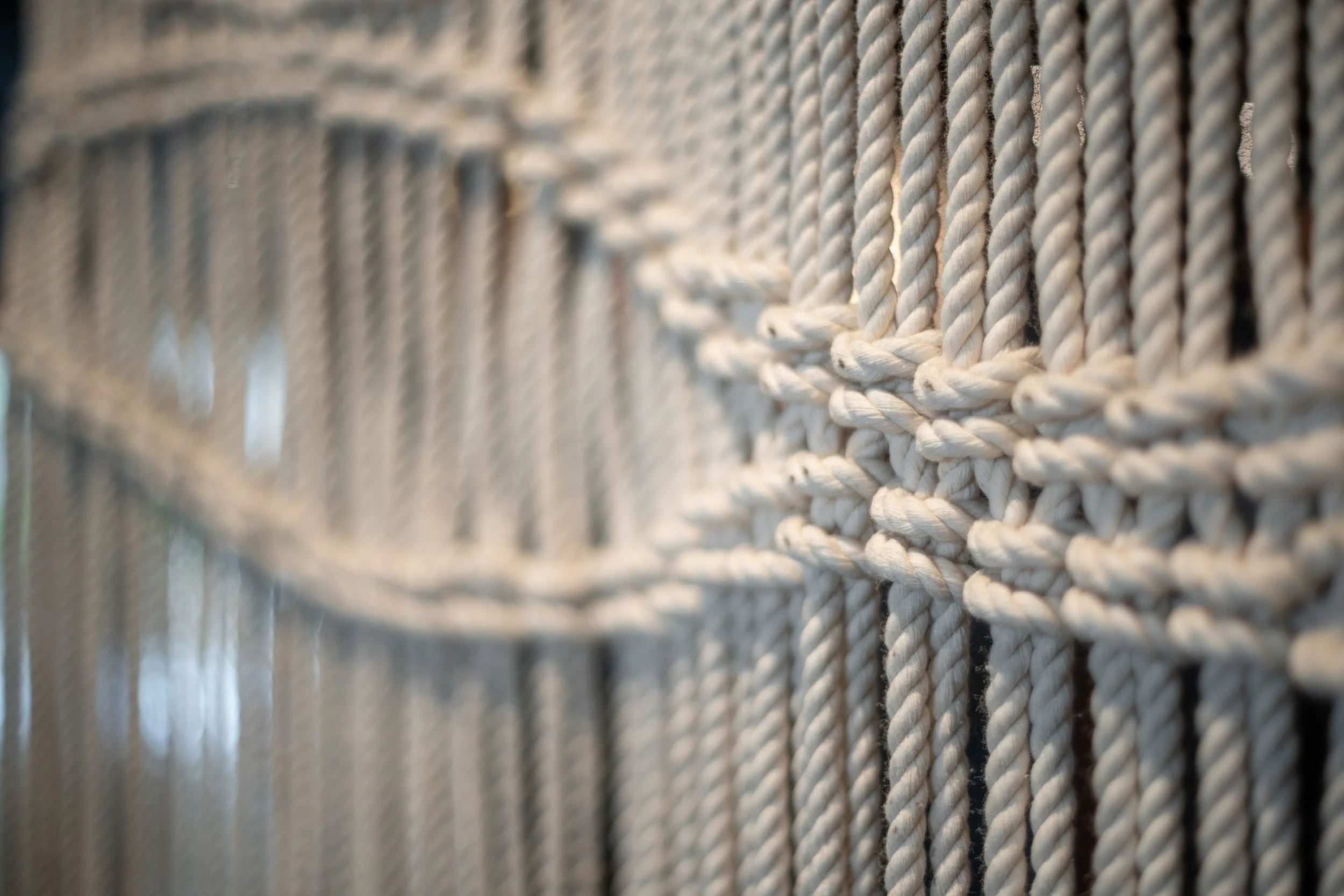 Close-up of macramé wall hanging with intricate knot pattern