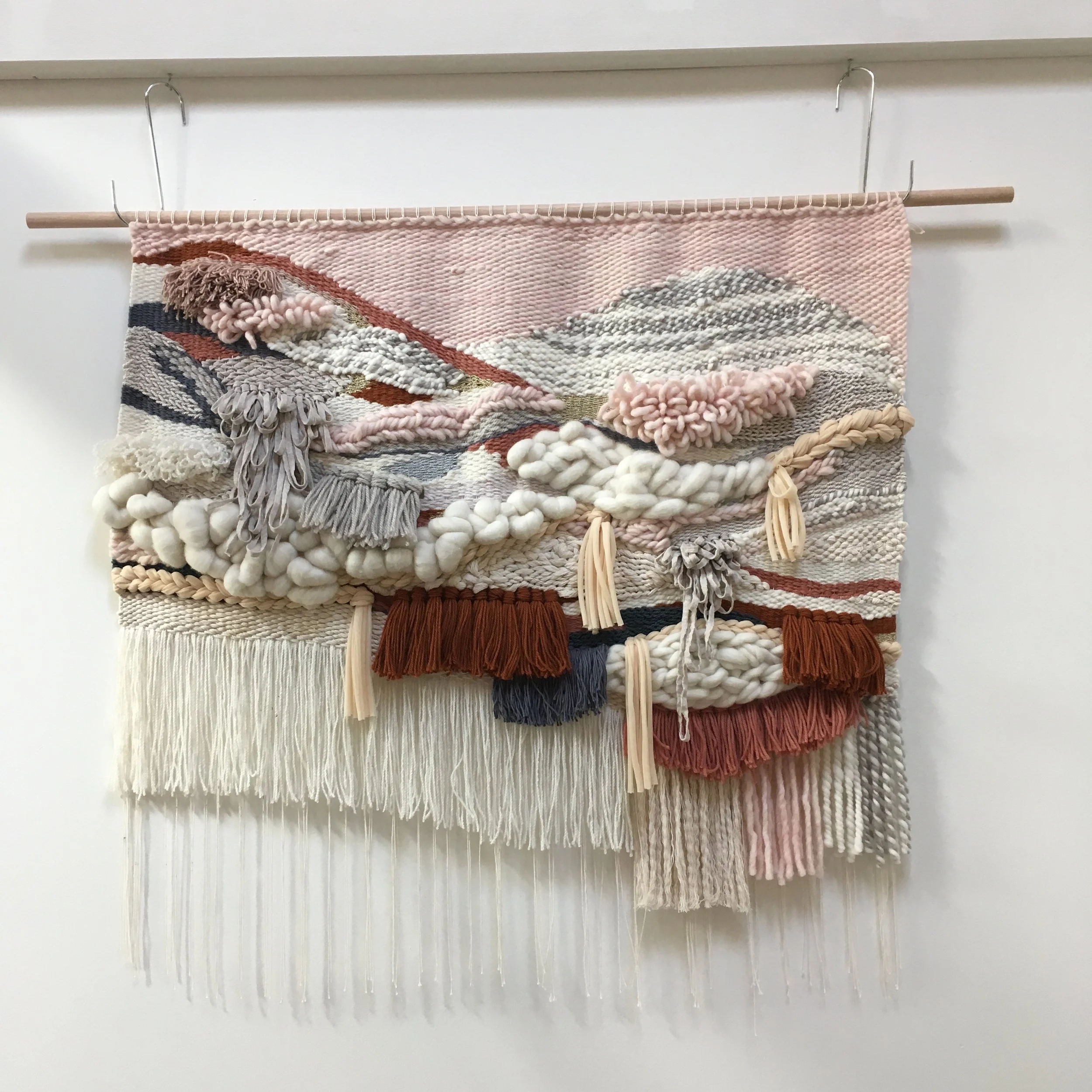 Colorful woven wall hanging with tassels