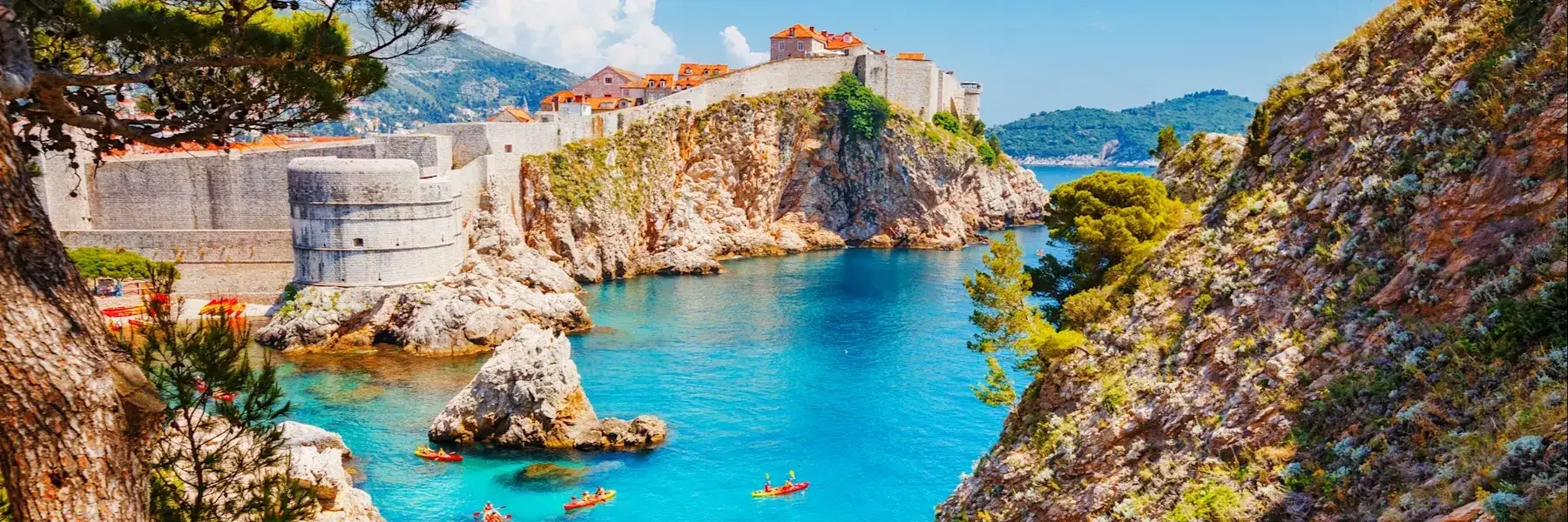 Dubrovnik City Walls with kayakers in the sea