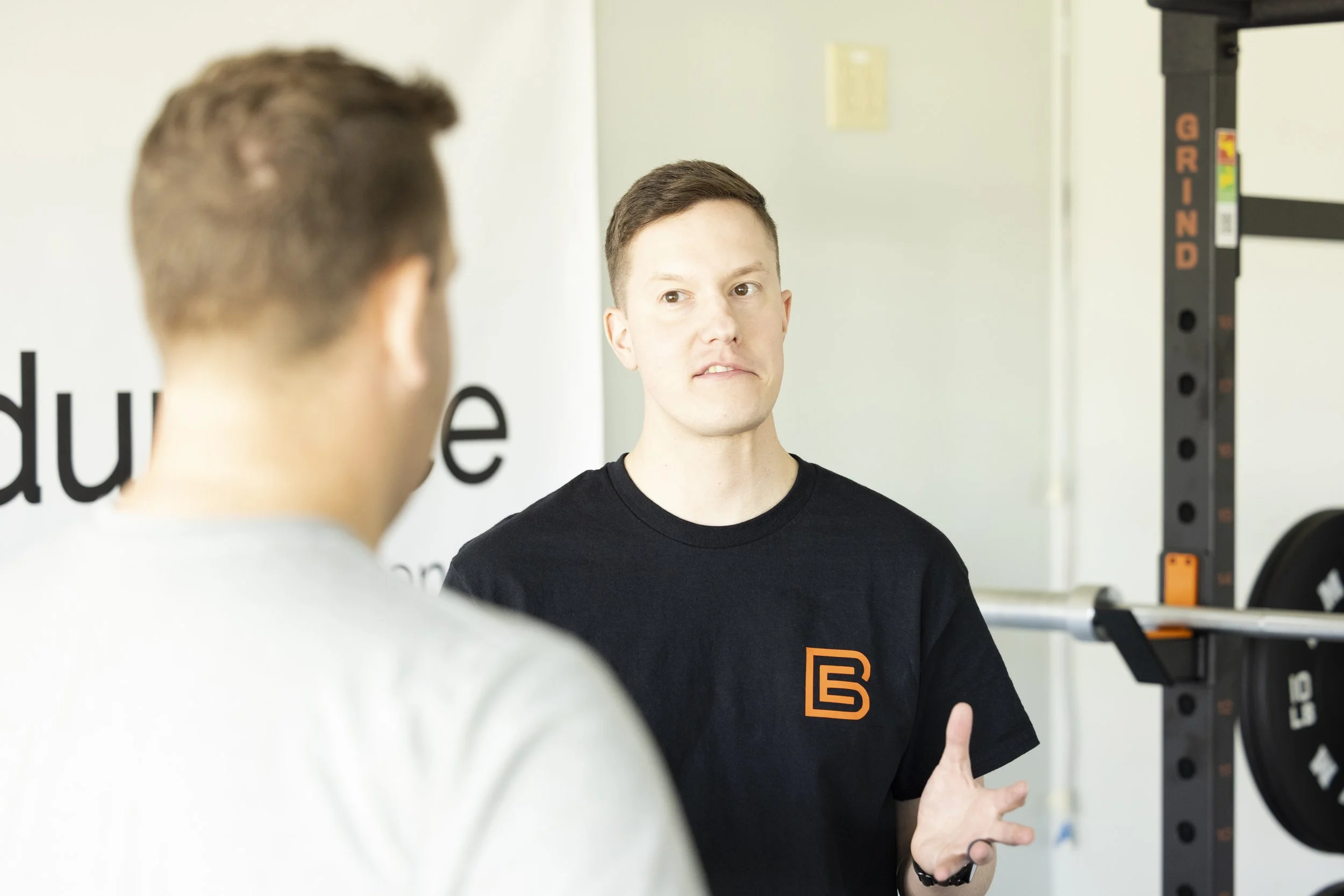 Sports physical therapist educating an injured runner in the clinic.