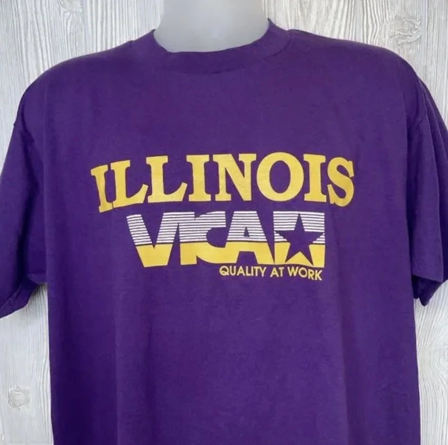 A purple t-shirt from Illinois VICA promotes the message “Quality at Work.”