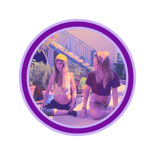 Two young women with purple hair sitting in a yoga pose outdoors, surrounded by plants and stairs in the background, under a purple border.